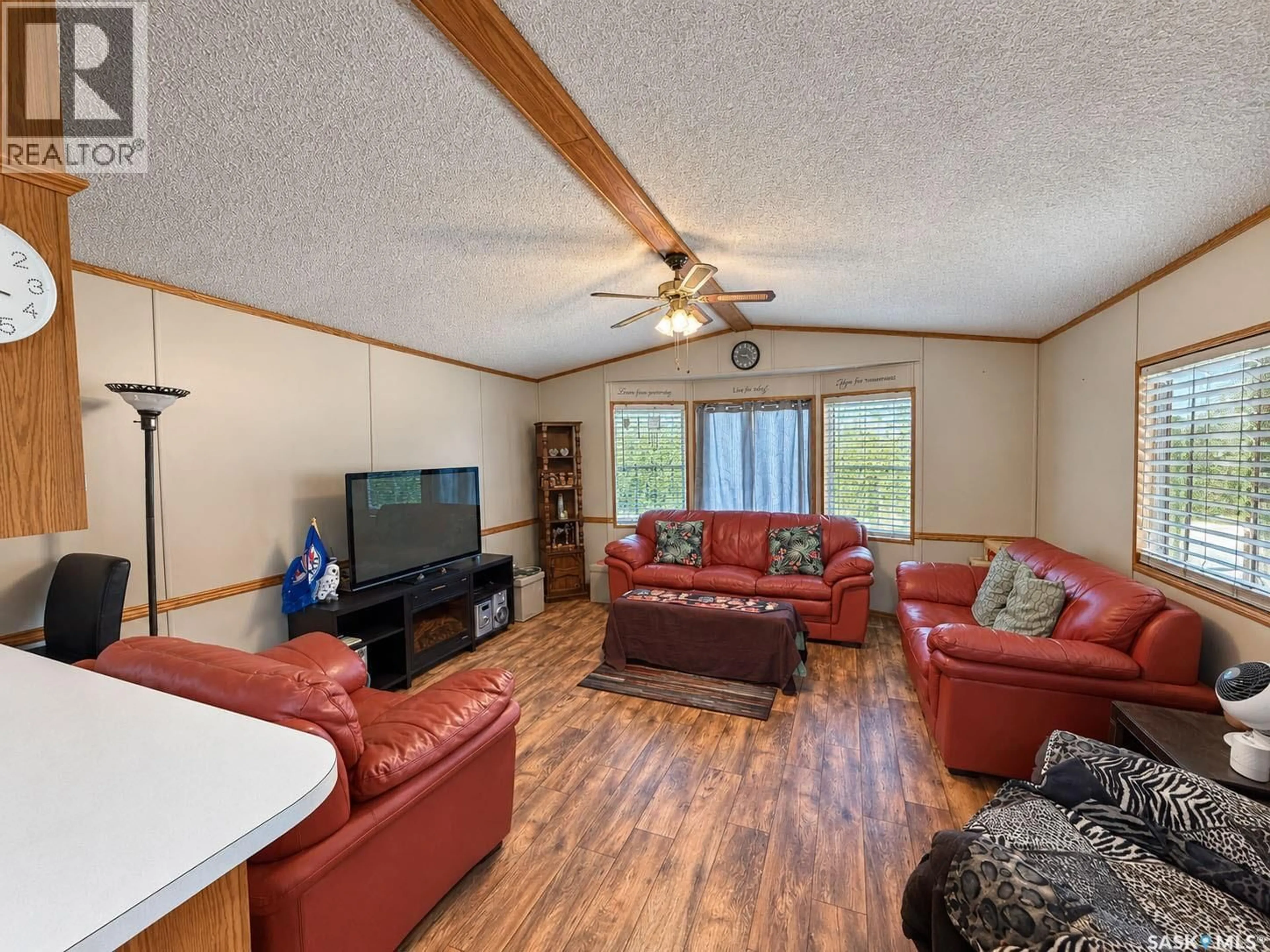 Living room with furniture, wood/laminate floor for 93 EASTVIEW COURT, Prince Albert Rm No. 461 Saskatchewan S6V5P9