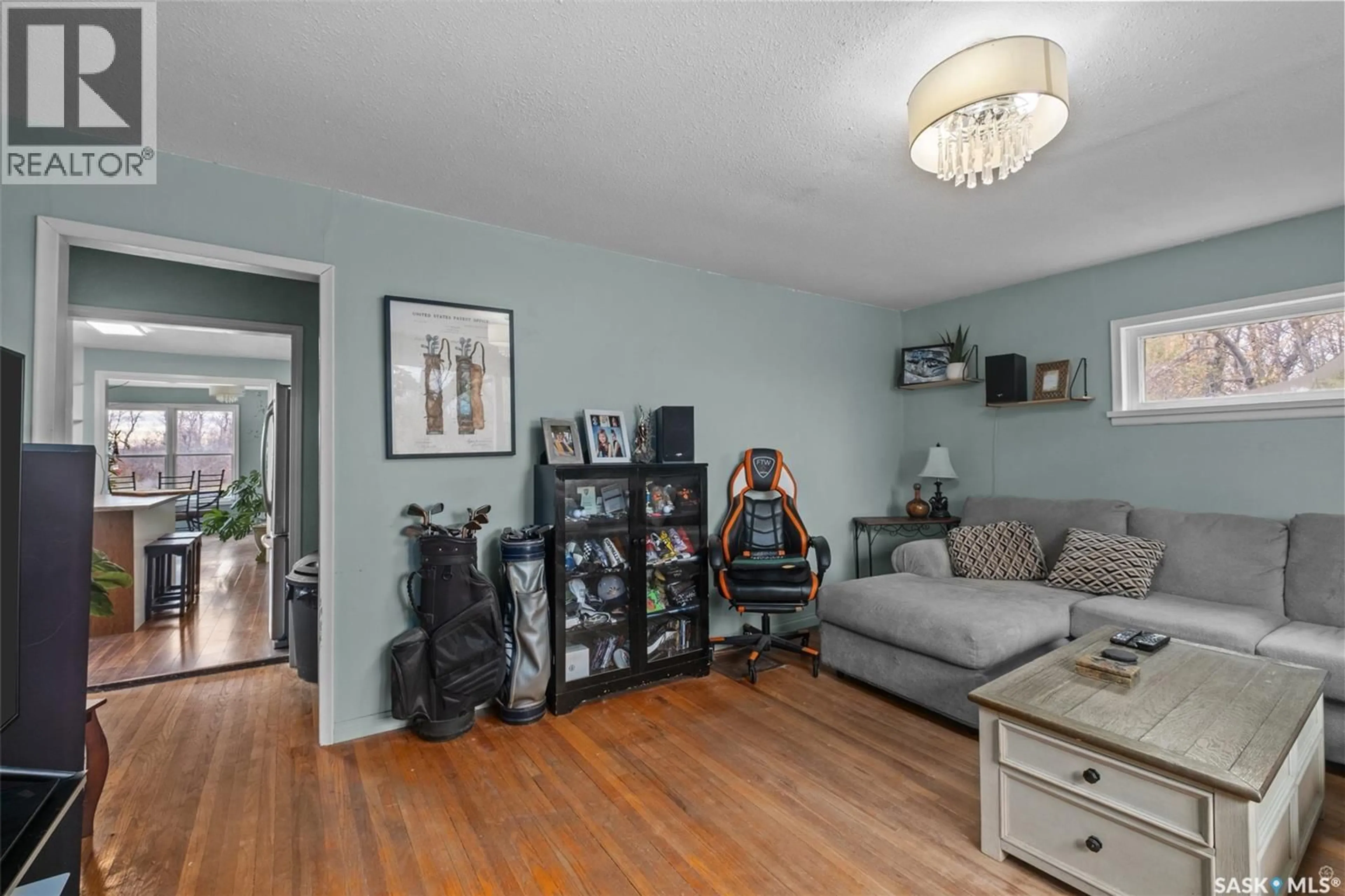 Living room with furniture, wood/laminate floor for 276 LINCOLN PARK ROAD, Prince Albert Rm No. 461 Saskatchewan S6V5R1