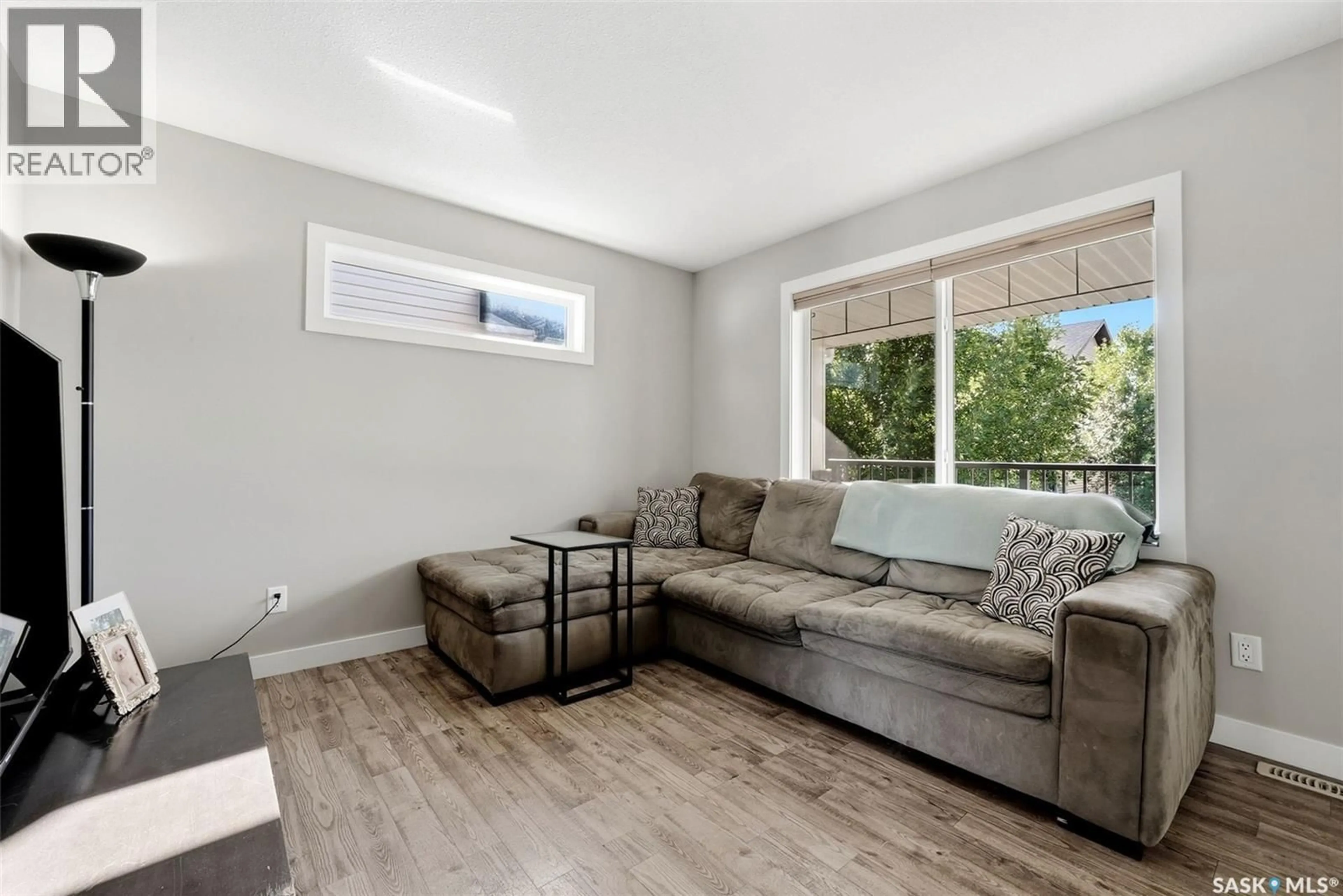 Living room with furniture, wood/laminate floor for 5434 MCCLELLAND DRIVE, Regina Saskatchewan S4W0K7