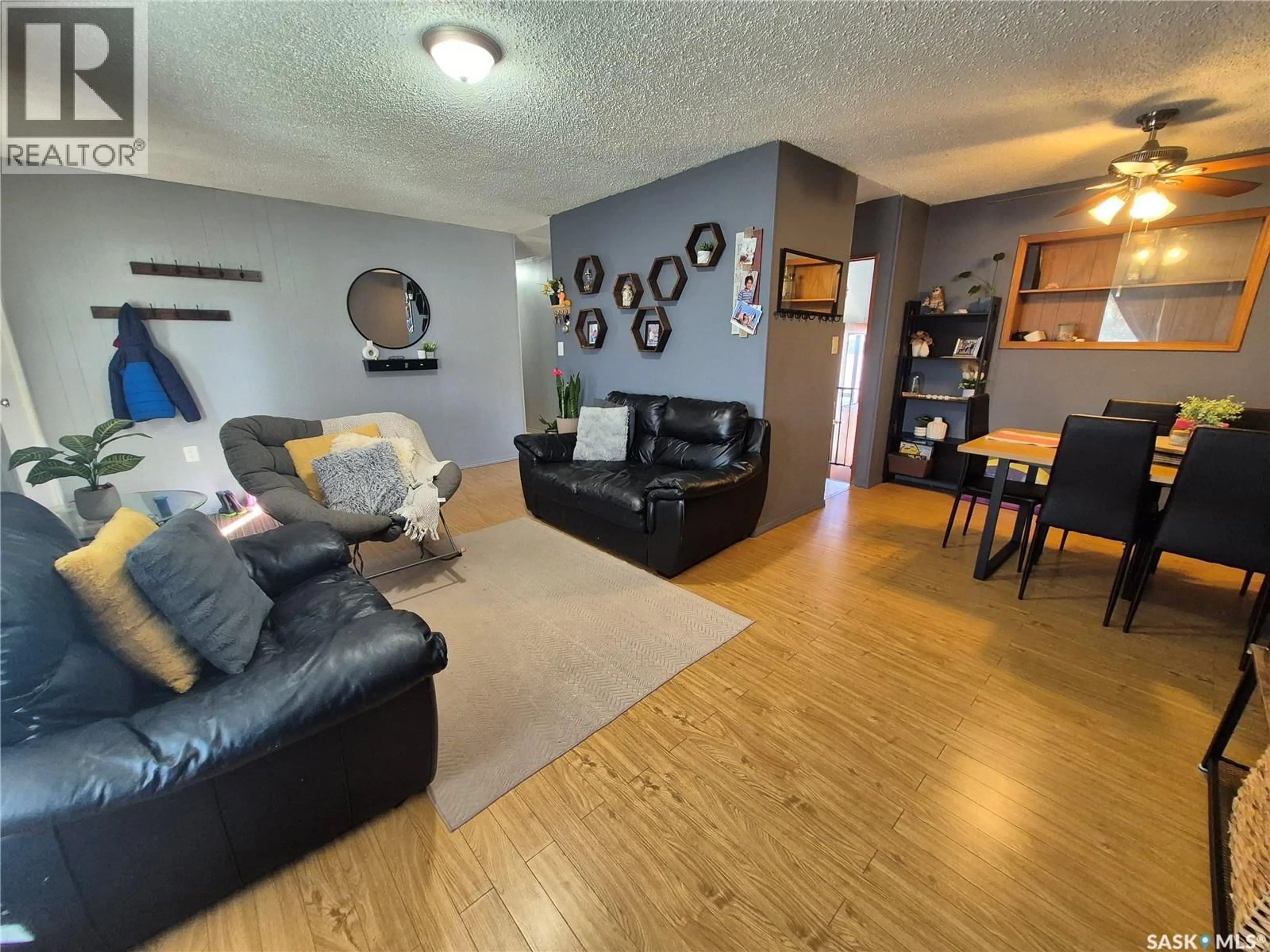 Living room with furniture, wood/laminate floor for 505 BERTRAND AVENUE, Radville Saskatchewan S0C2G0