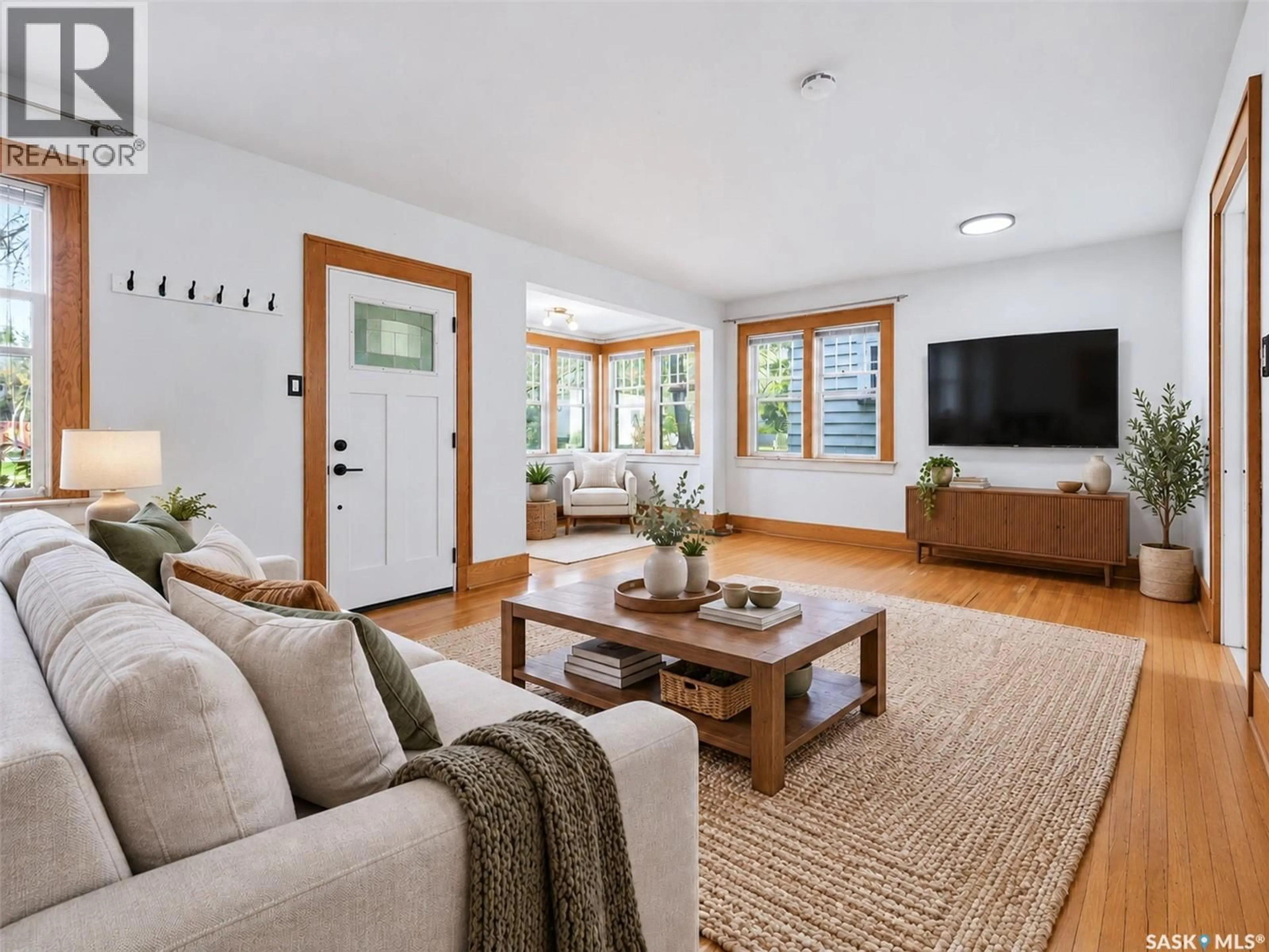 Living room with furniture, wood/laminate floor for 615 CLARENCE AVENUE, Saskatoon Saskatchewan S7H2E1