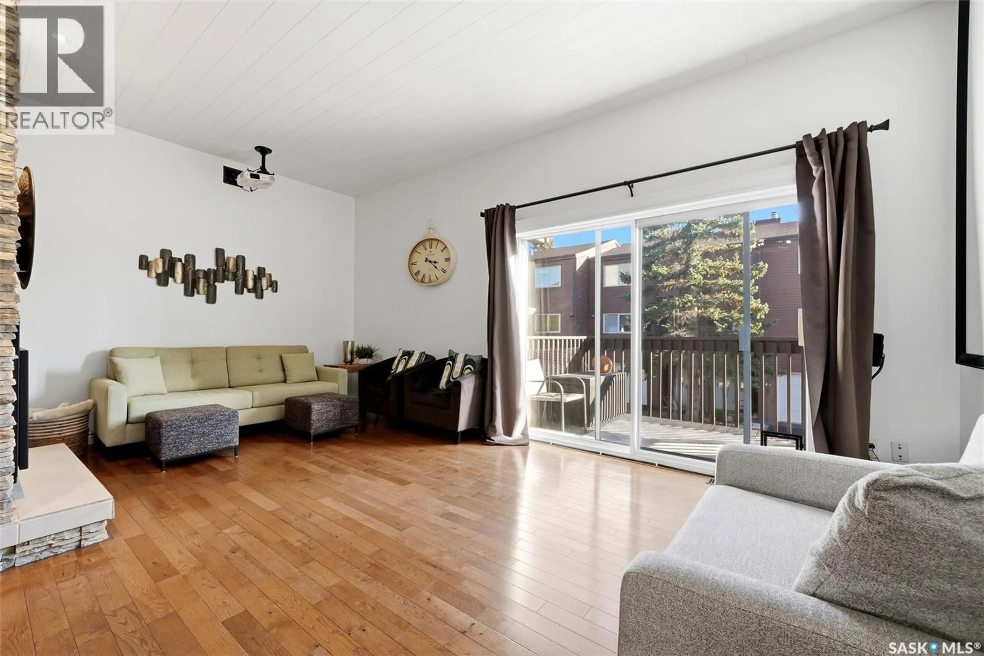 Living room with furniture, wood/laminate floor for 10 ASGAR WALK, Regina Saskatchewan S4S6W4
