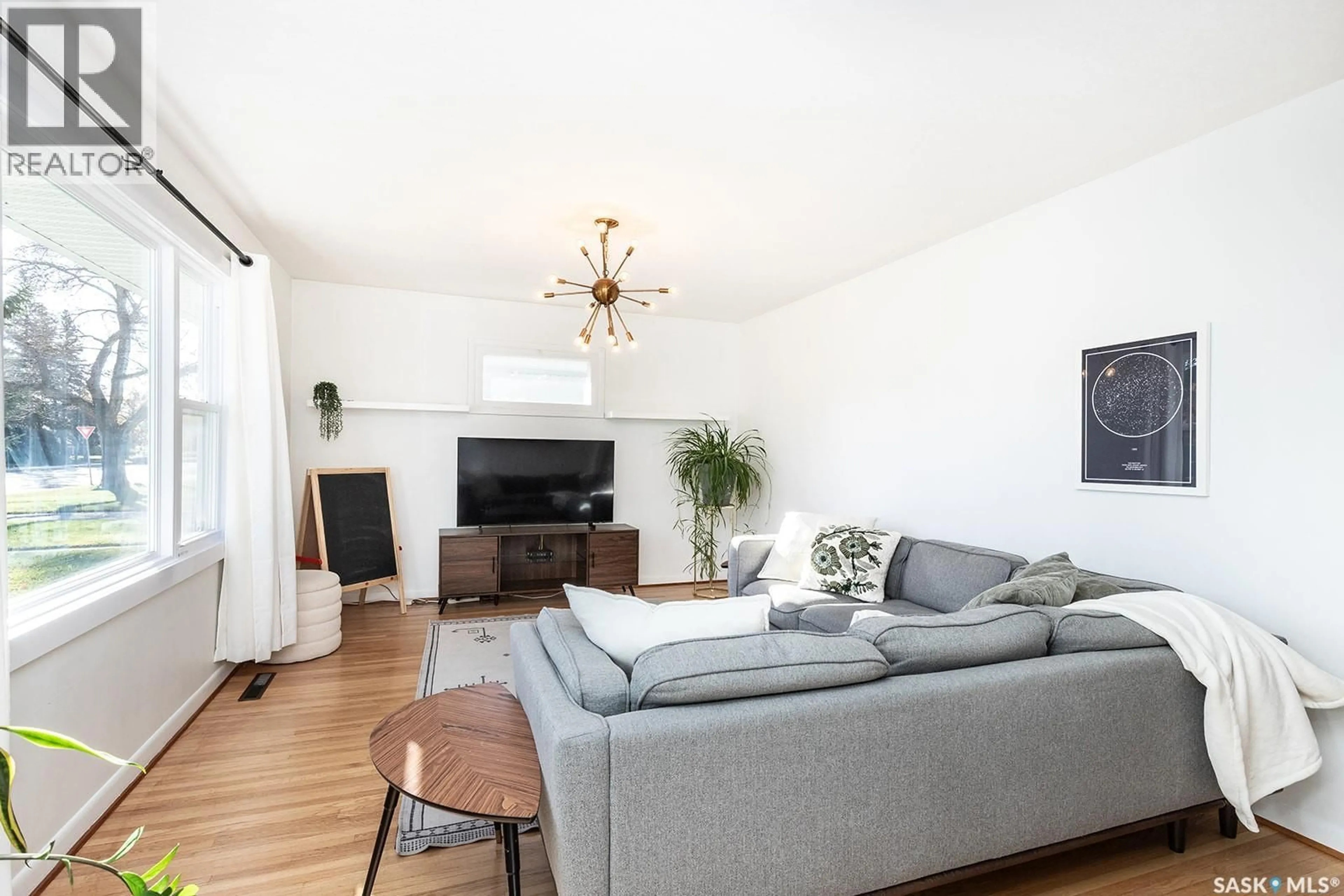 Living room with furniture, wood/laminate floor for 1914 LANSDOWNE AVENUE, Saskatoon Saskatchewan S7J1G3