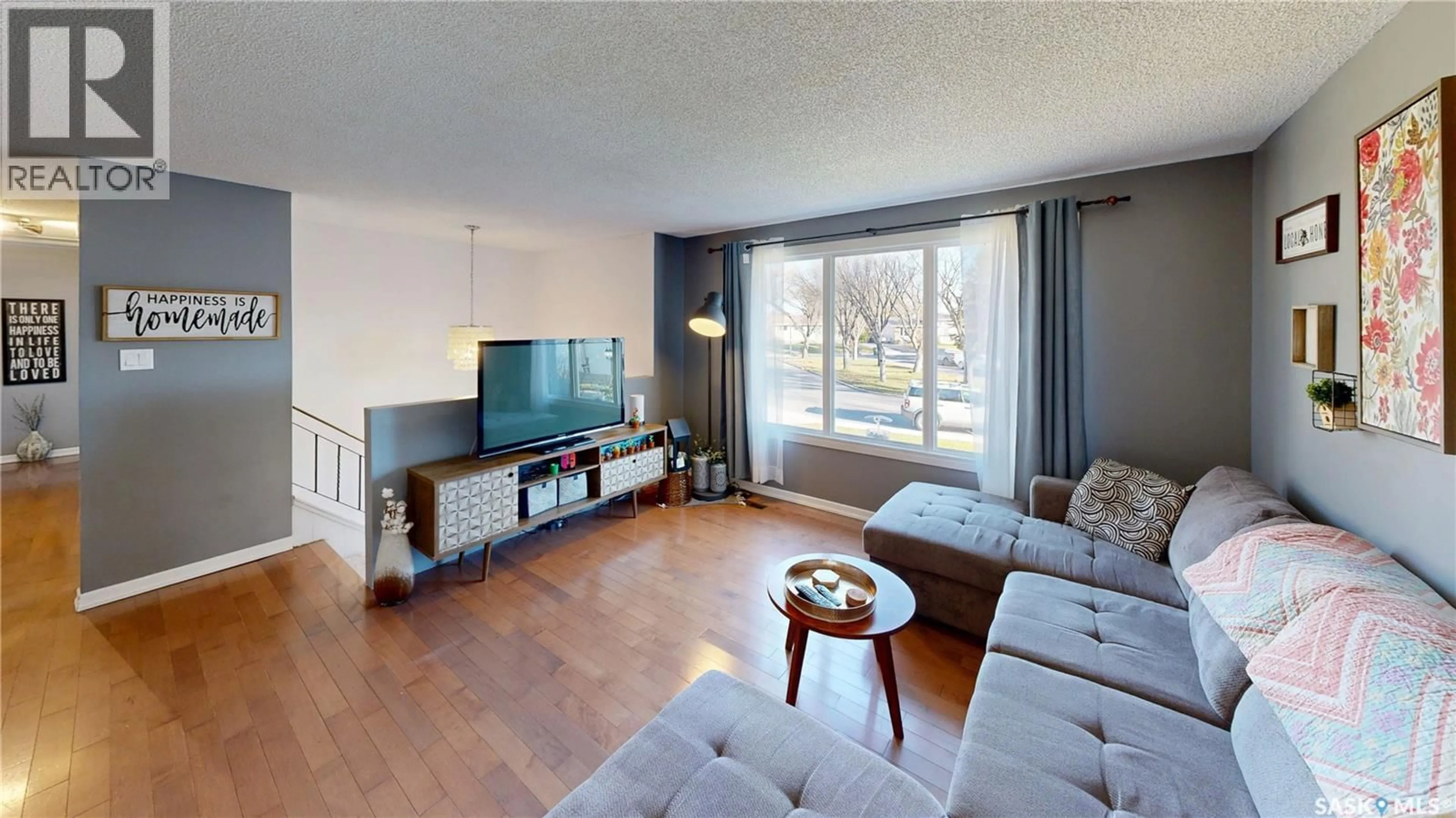 Living room with furniture, wood/laminate floor for 51 FRENCH CRESCENT, Regina Saskatchewan S4R6N3