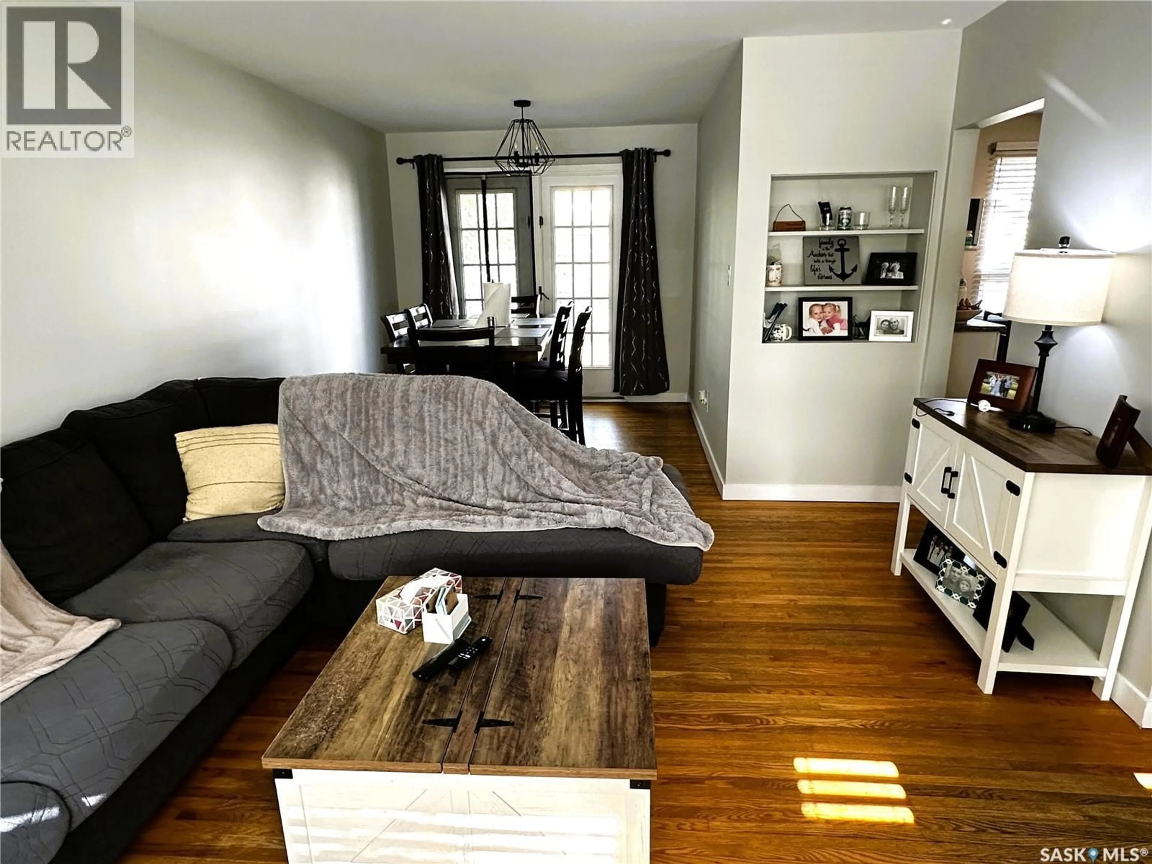 Living room with furniture, wood/laminate floor for 3818 NORMANDY AVENUE, Regina Saskatchewan S4S0Y3