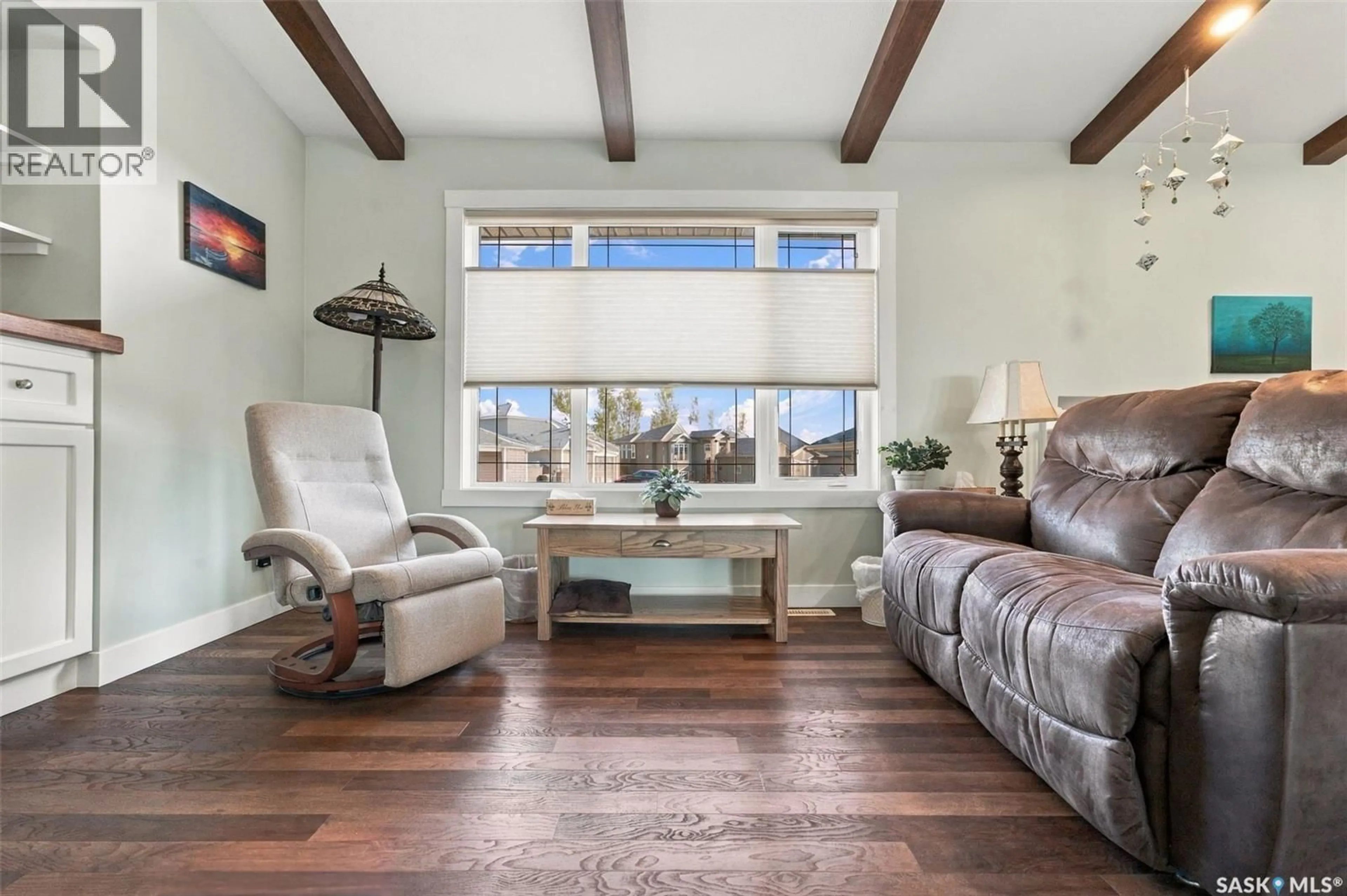 Living room with furniture, wood/laminate floor for 878 CEDAR TERRACE, Martensville Saskatchewan S0K2T2