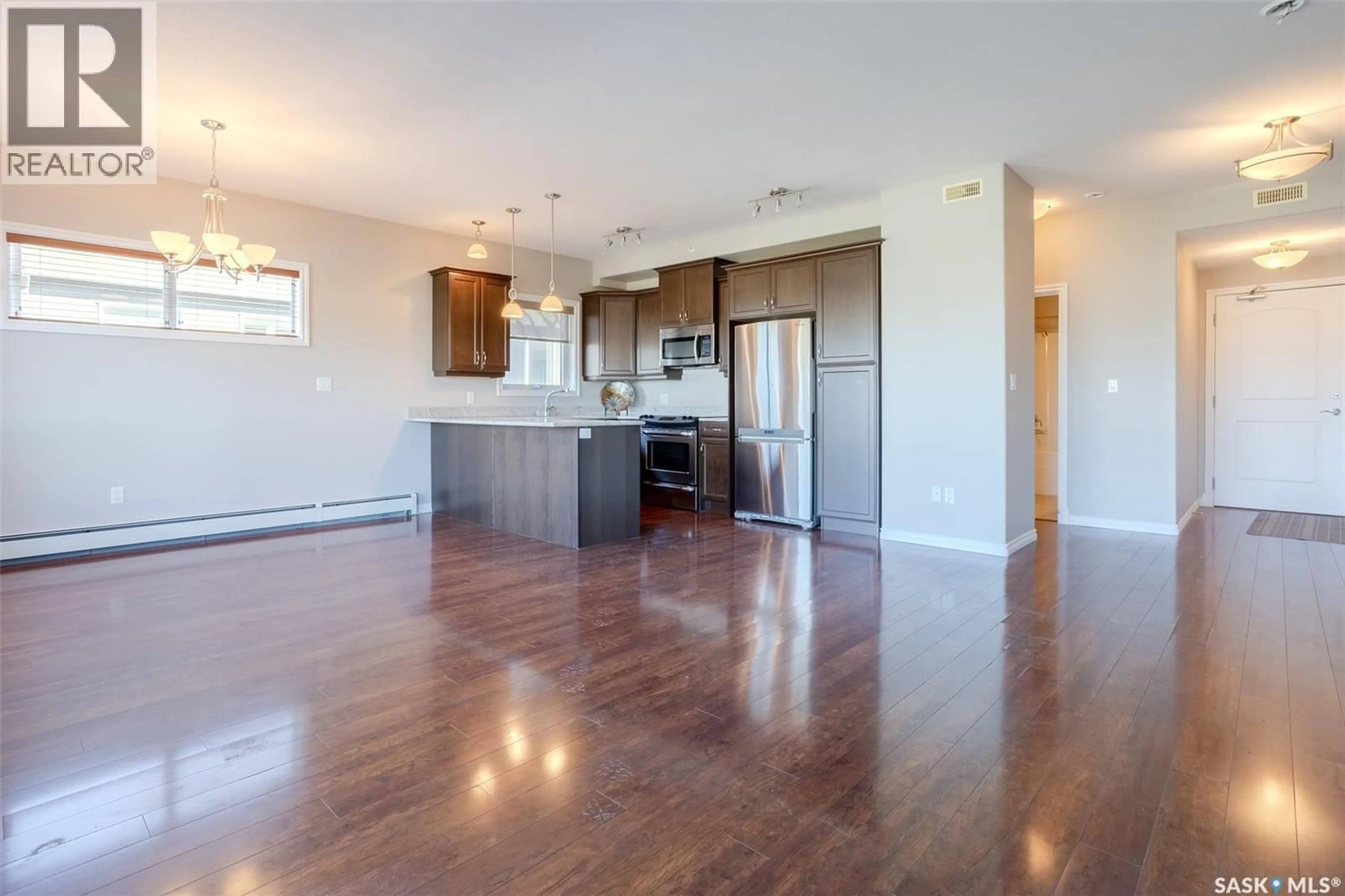 Open concept kitchen, wood/laminate floor for 321 2710 MAIN STREET, Saskatoon Saskatchewan S7H0M3