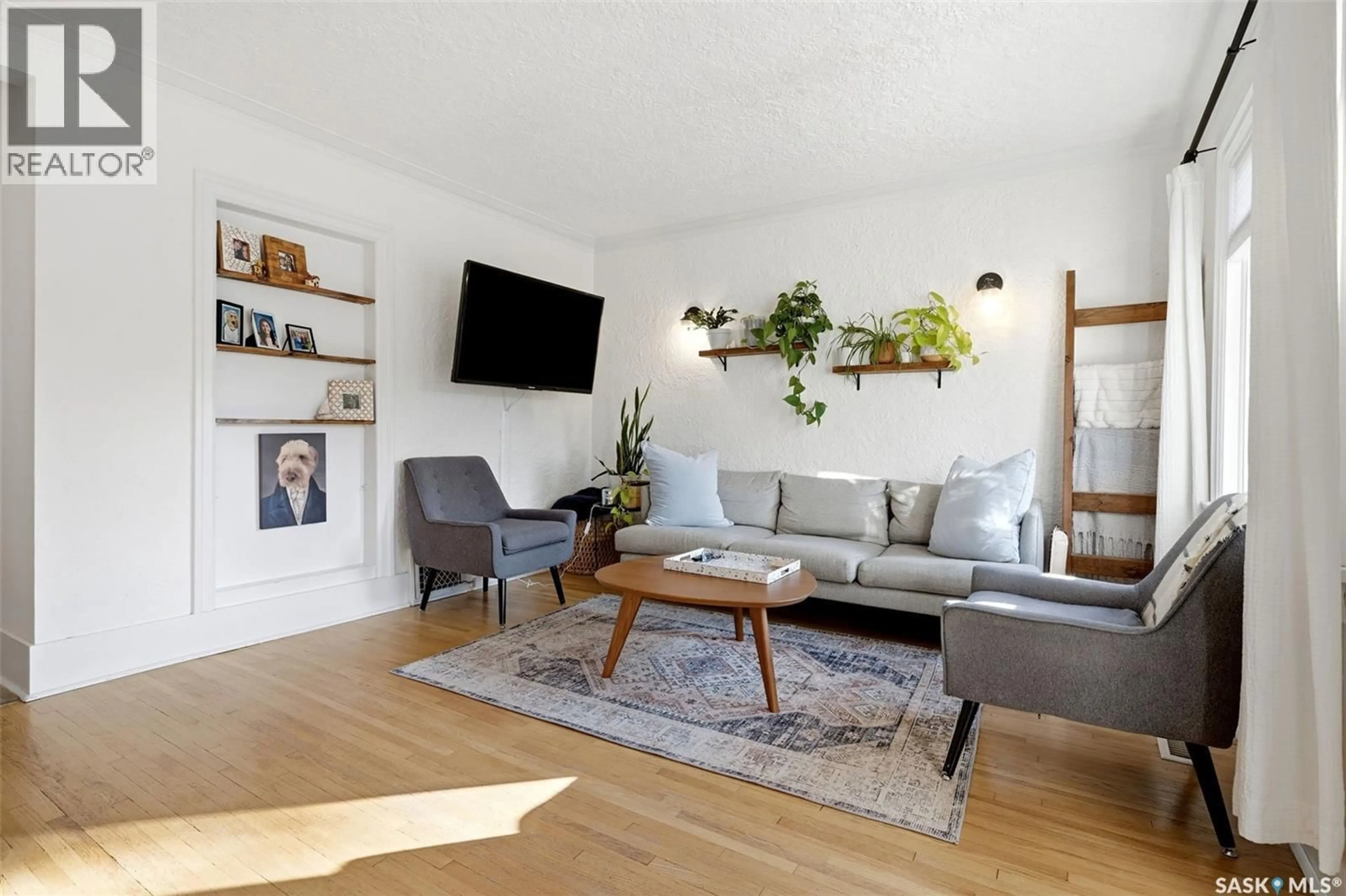 Living room with furniture, wood/laminate floor for 2263 QUEEN STREET, Regina Saskatchewan S4T4C6