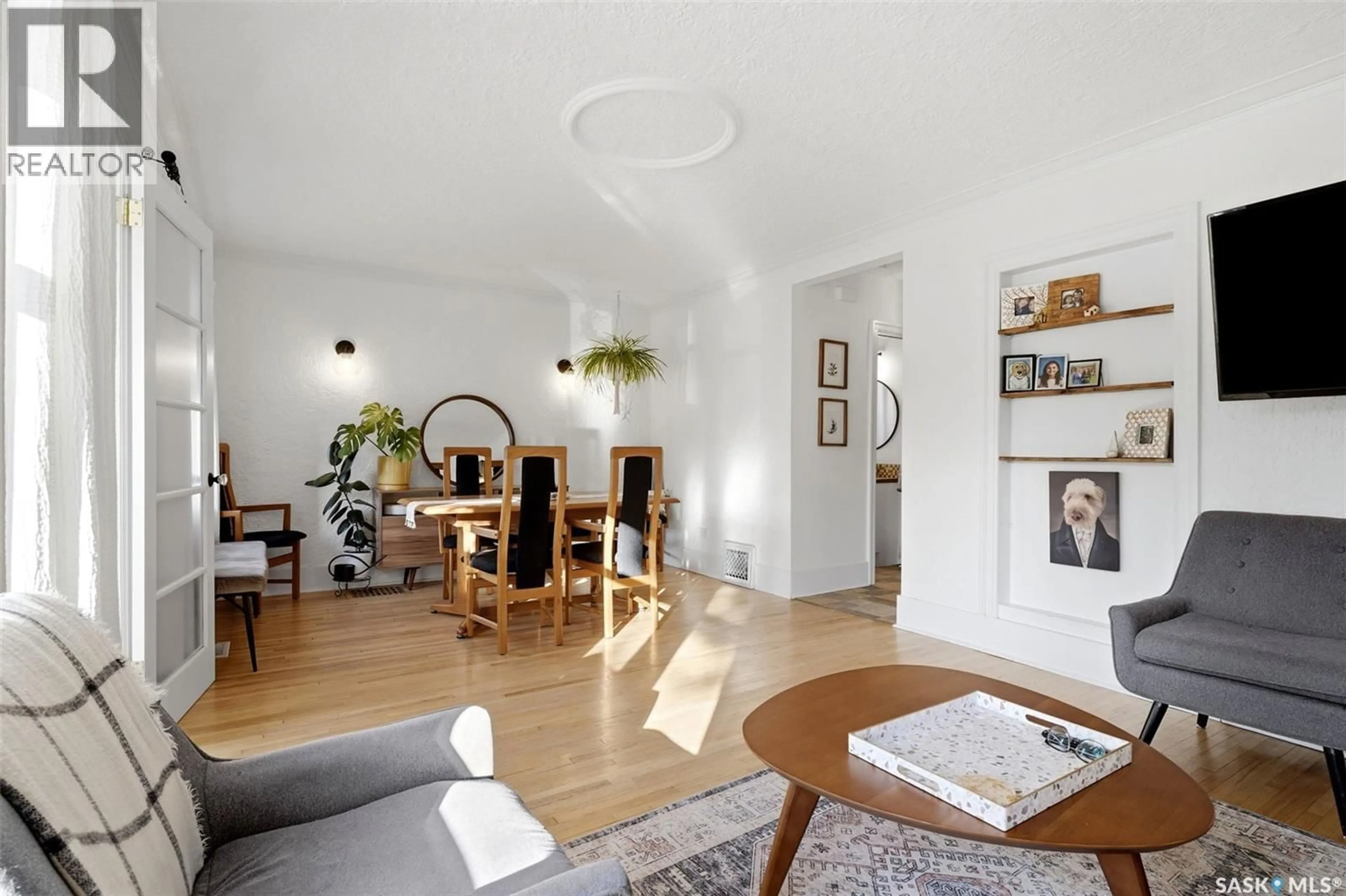 Living room with furniture, wood/laminate floor for 2263 QUEEN STREET, Regina Saskatchewan S4T4C6