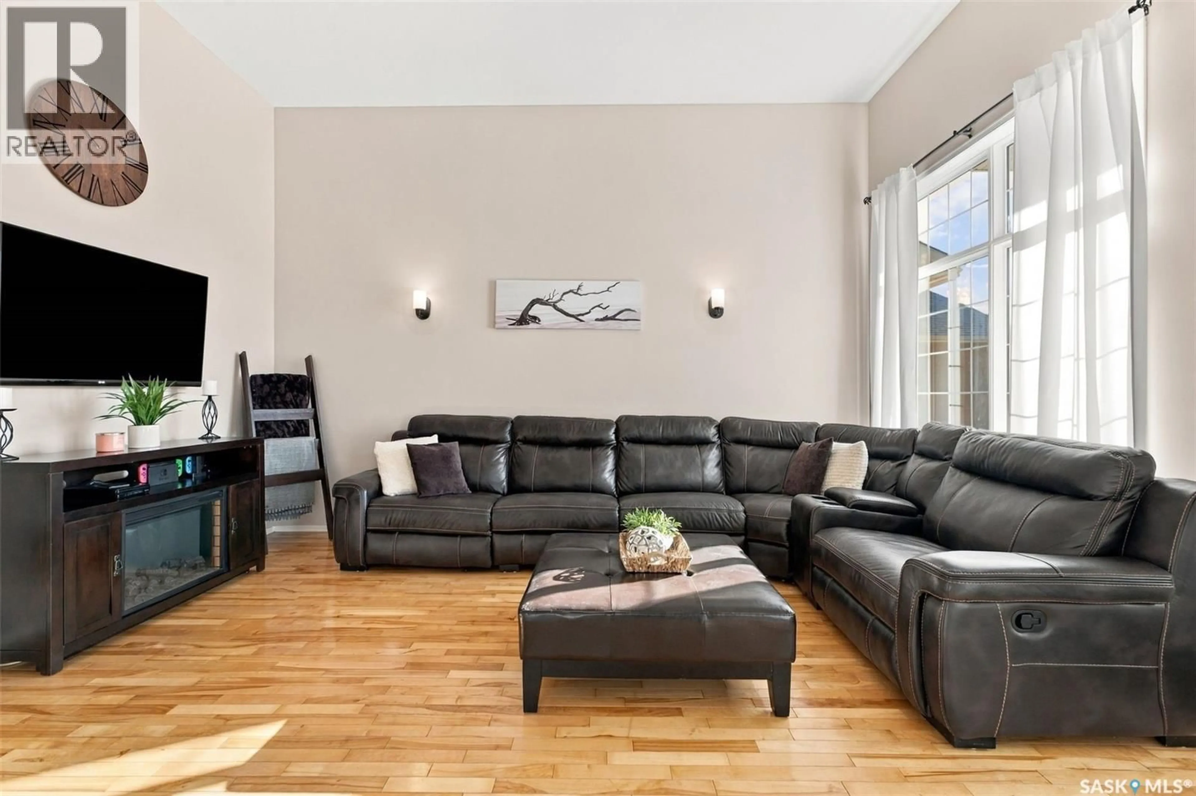 Living room with furniture, wood/laminate floor for 107 SEARS COVE, Saskatoon Saskatchewan S7N4V5