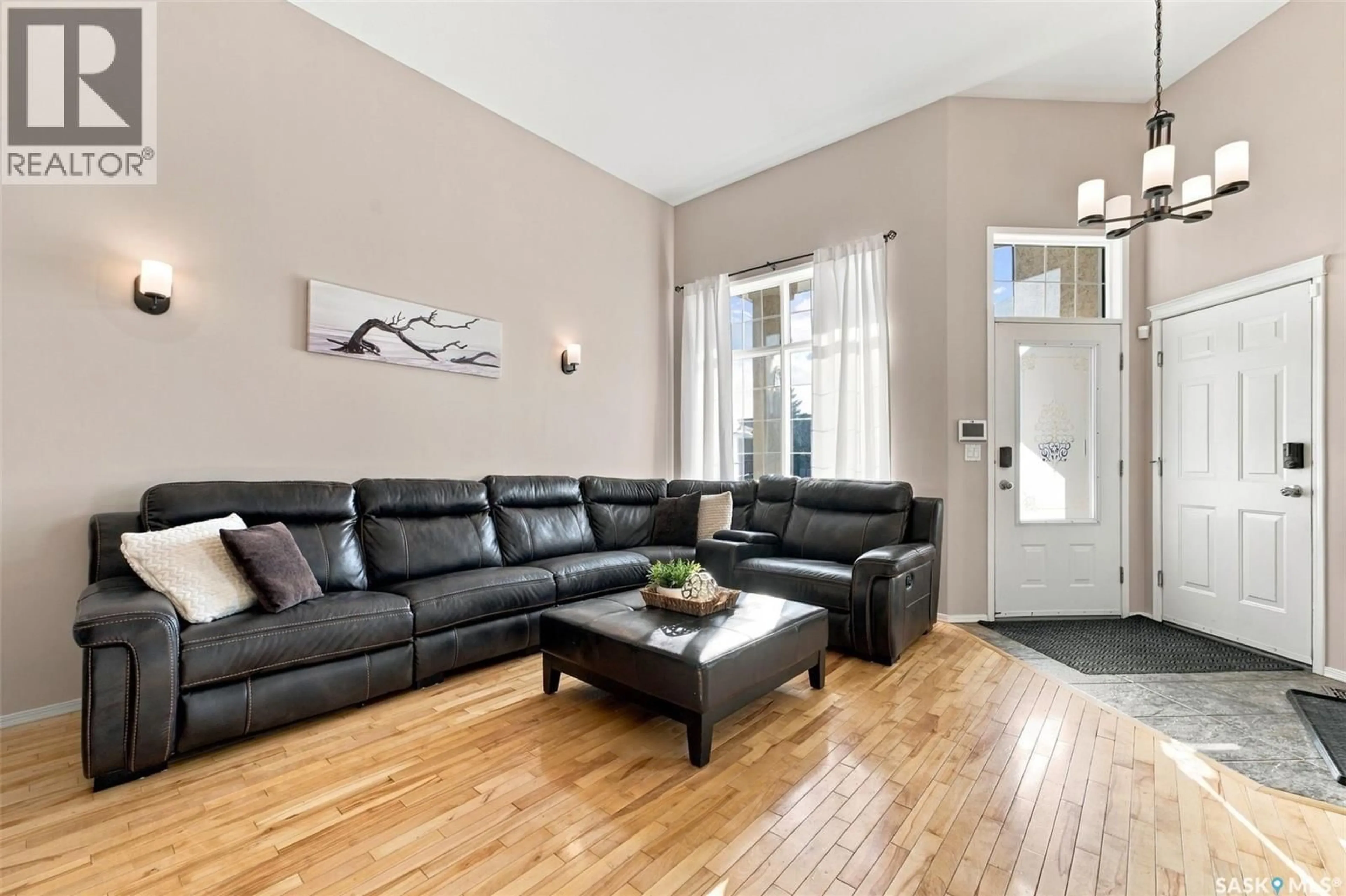 Living room with furniture, wood/laminate floor for 107 SEARS COVE, Saskatoon Saskatchewan S7N4V5