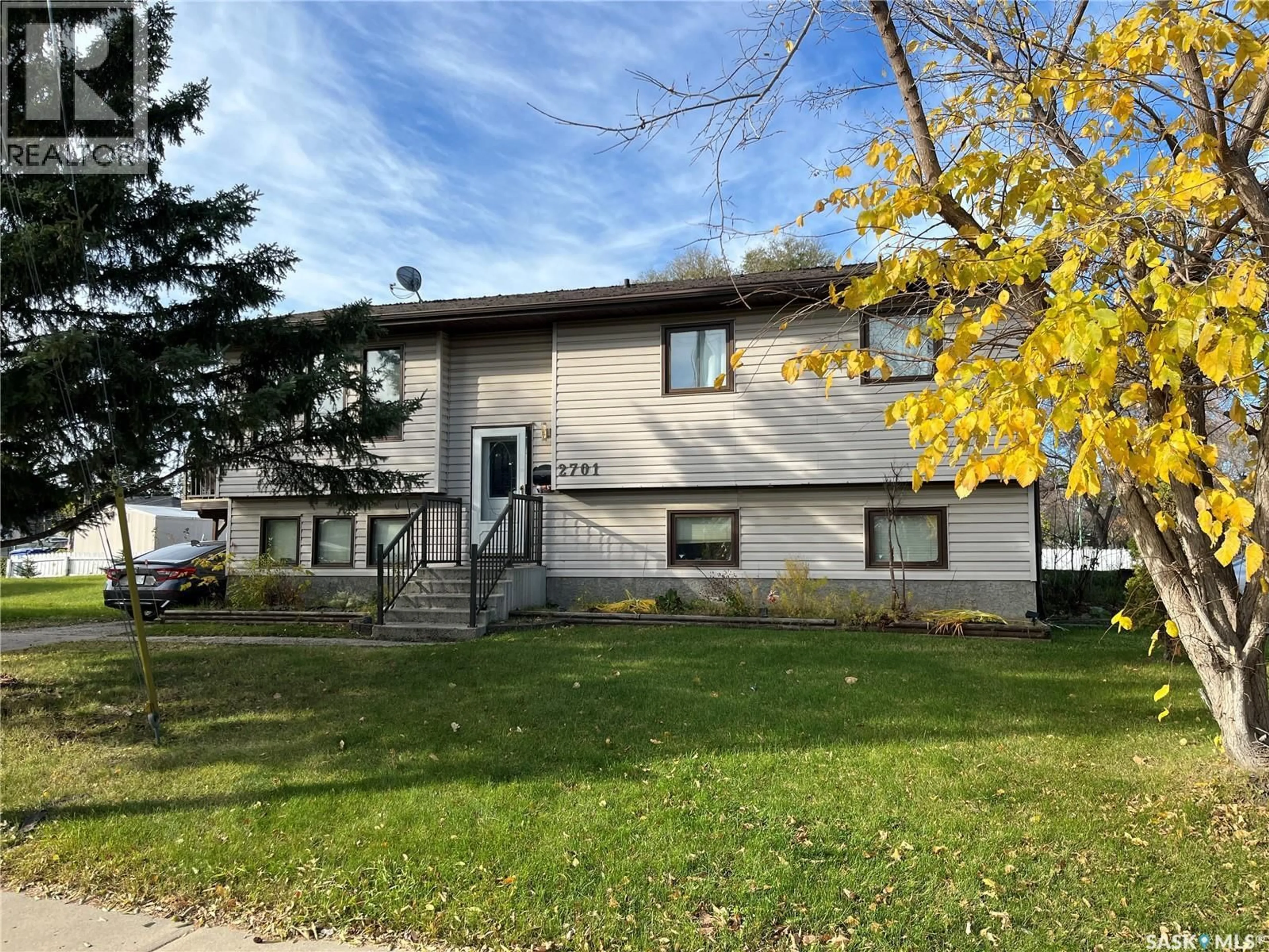 Home with vinyl exterior material, street for 2701 1ST AVENUE, Prince Albert Saskatchewan S6V5E6
