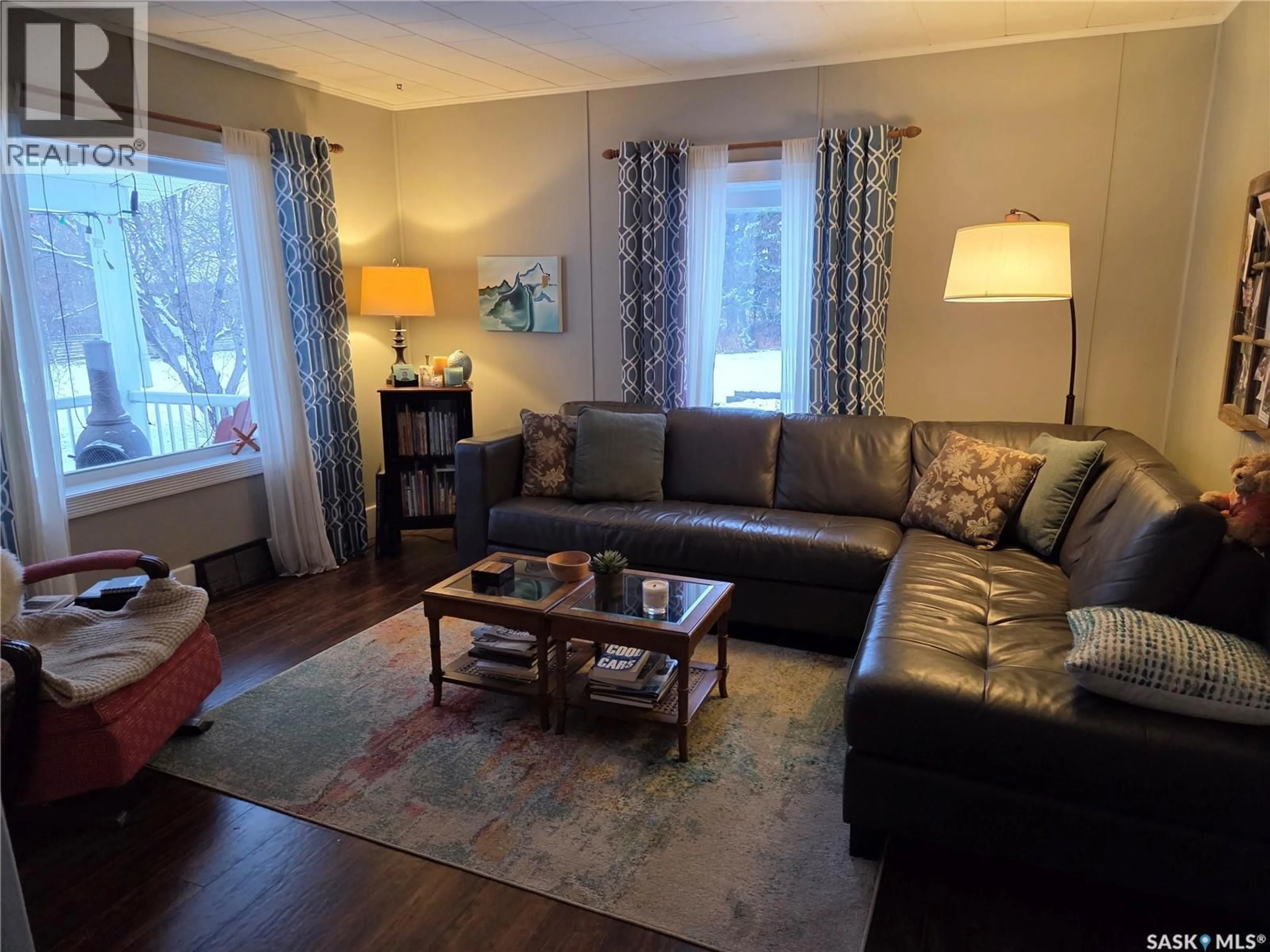 Living room with furniture, wood/laminate floor for 213 FIRST AVENUE, Hyas Saskatchewan S0A1K0