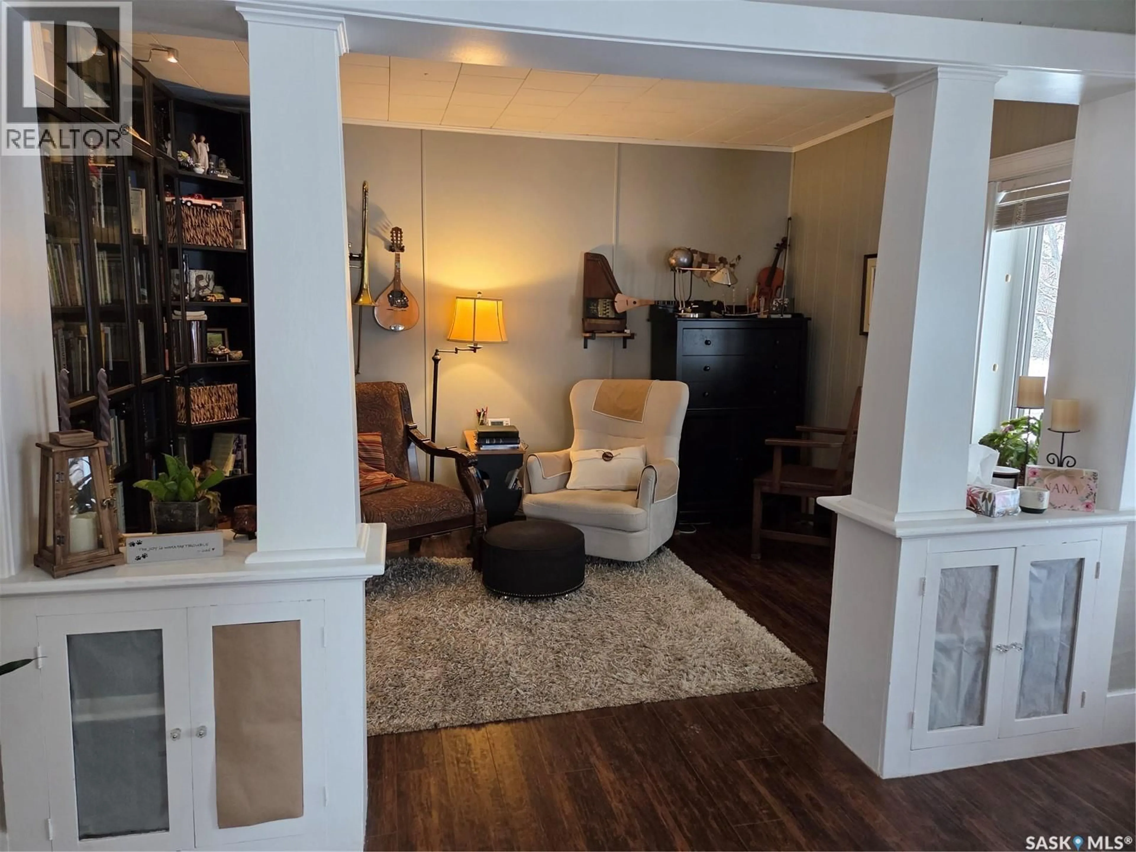 Living room with furniture, wood/laminate floor for 213 FIRST AVENUE, Hyas Saskatchewan S0A1K0