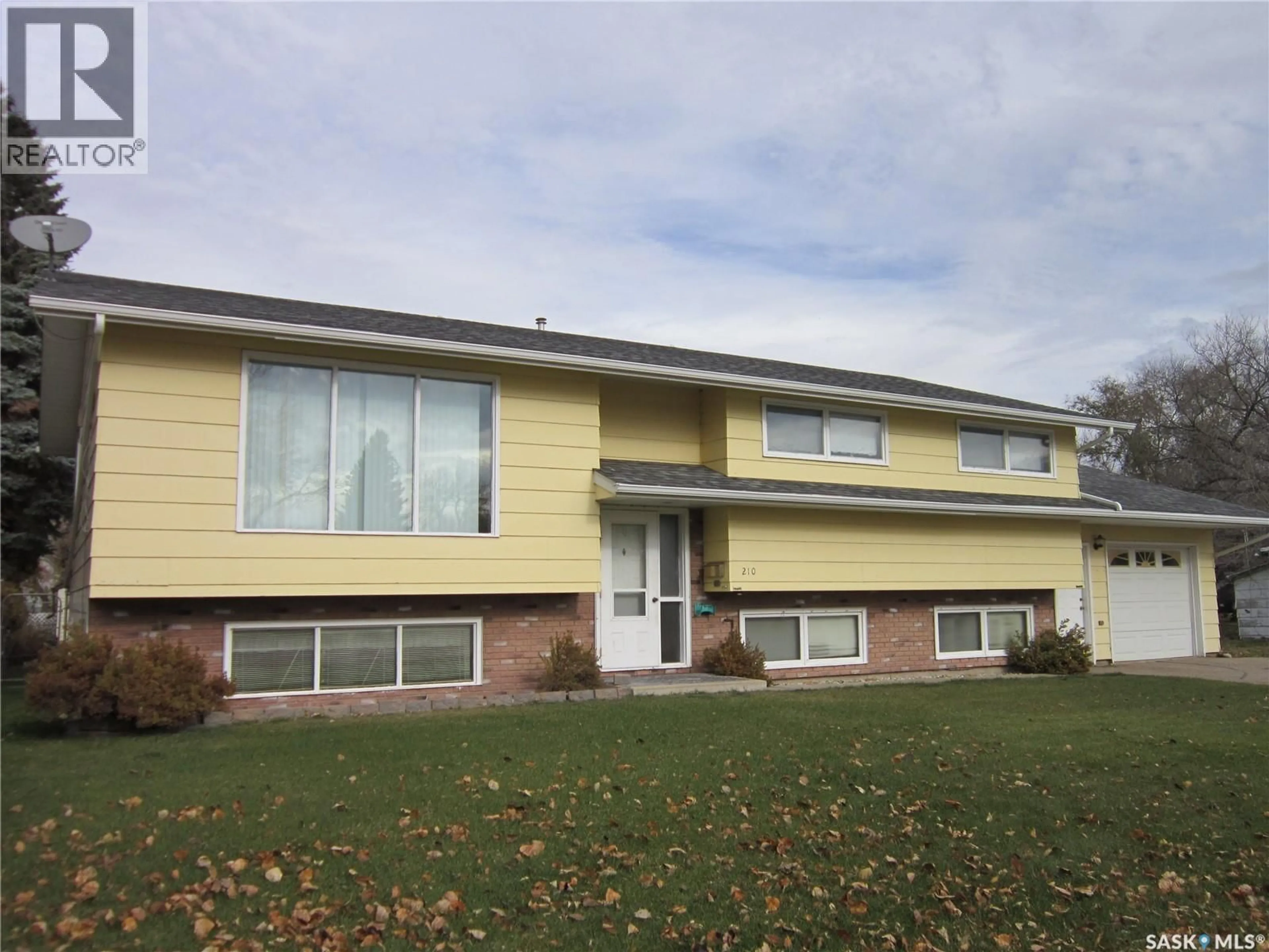 Home with vinyl exterior material, street for 210 1ST STREET, Wakaw Saskatchewan S0K4P0