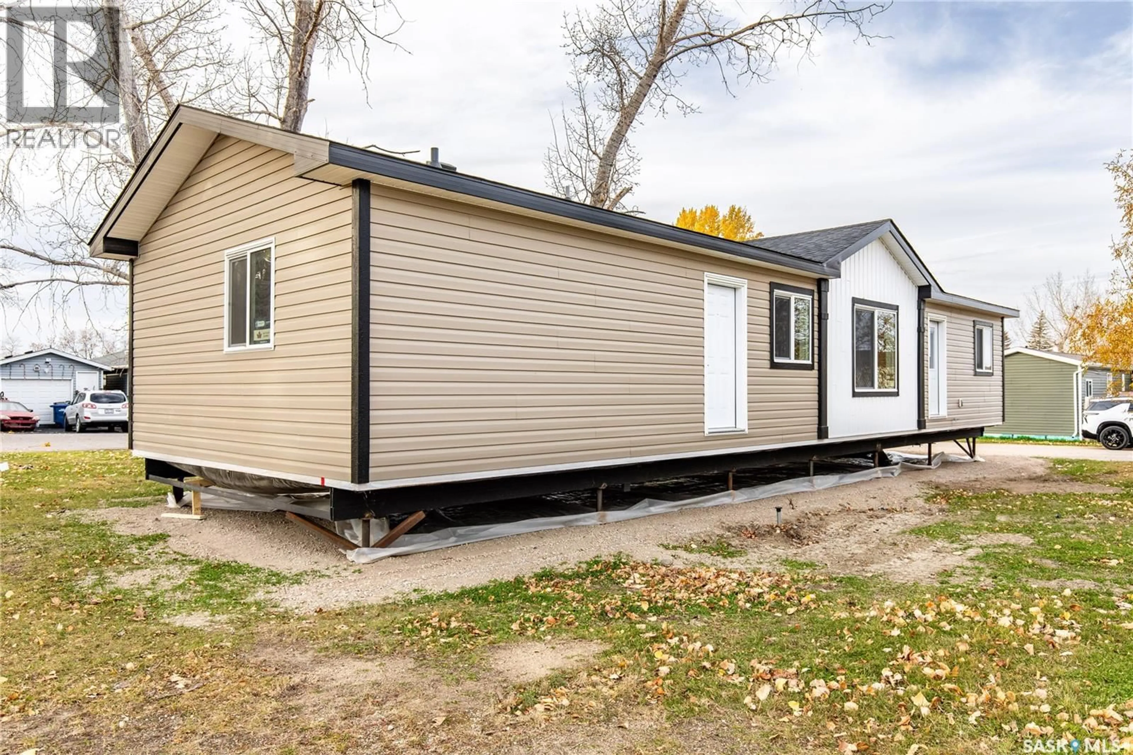 Home with vinyl exterior material, street for F9 - 1455 9TH AVENUE, Moose Jaw Saskatchewan S6J1C6