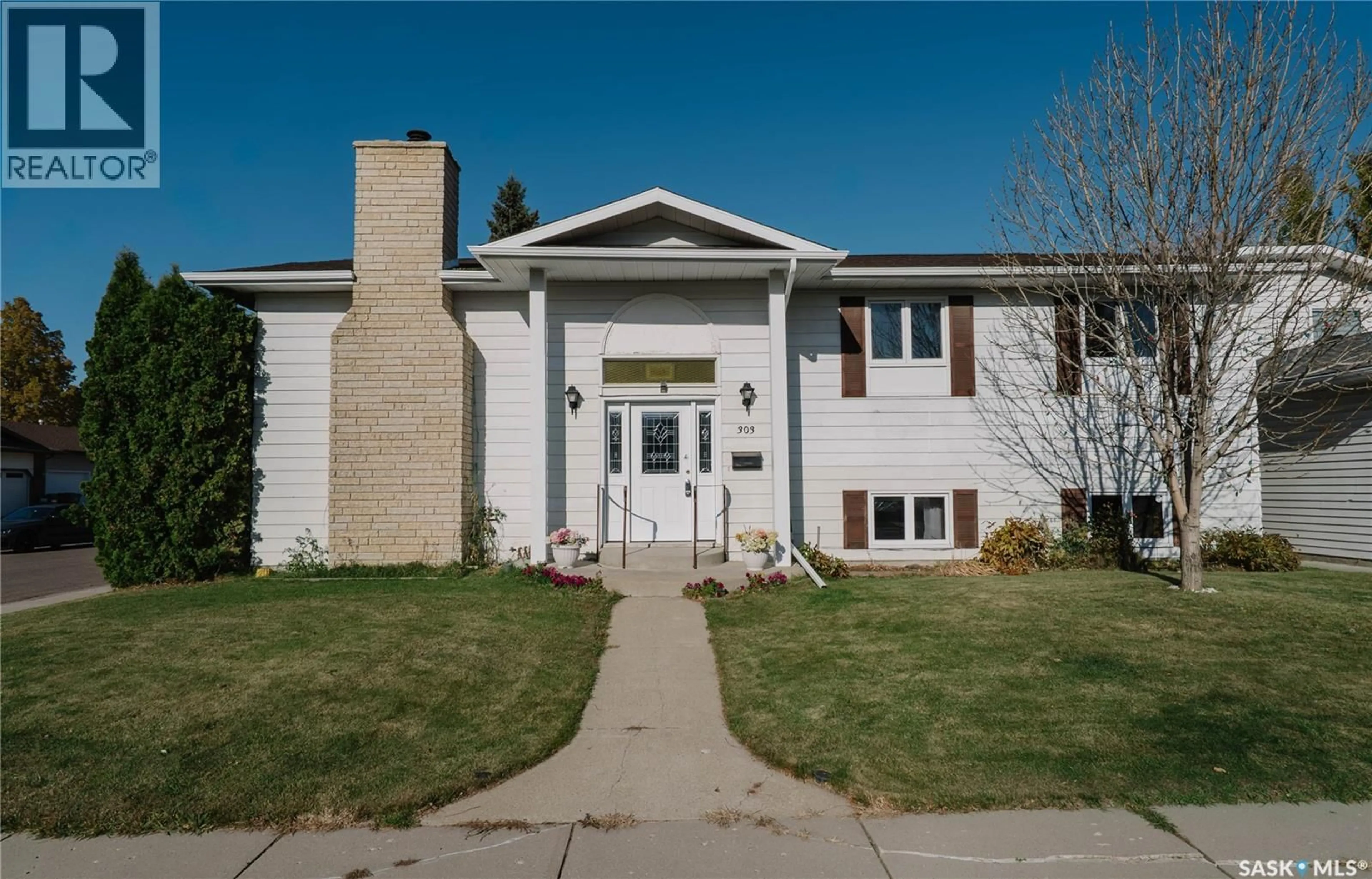 Home with vinyl exterior material, street for 303 STAIGH CRESCENT, Saskatoon Saskatchewan S7N3T5