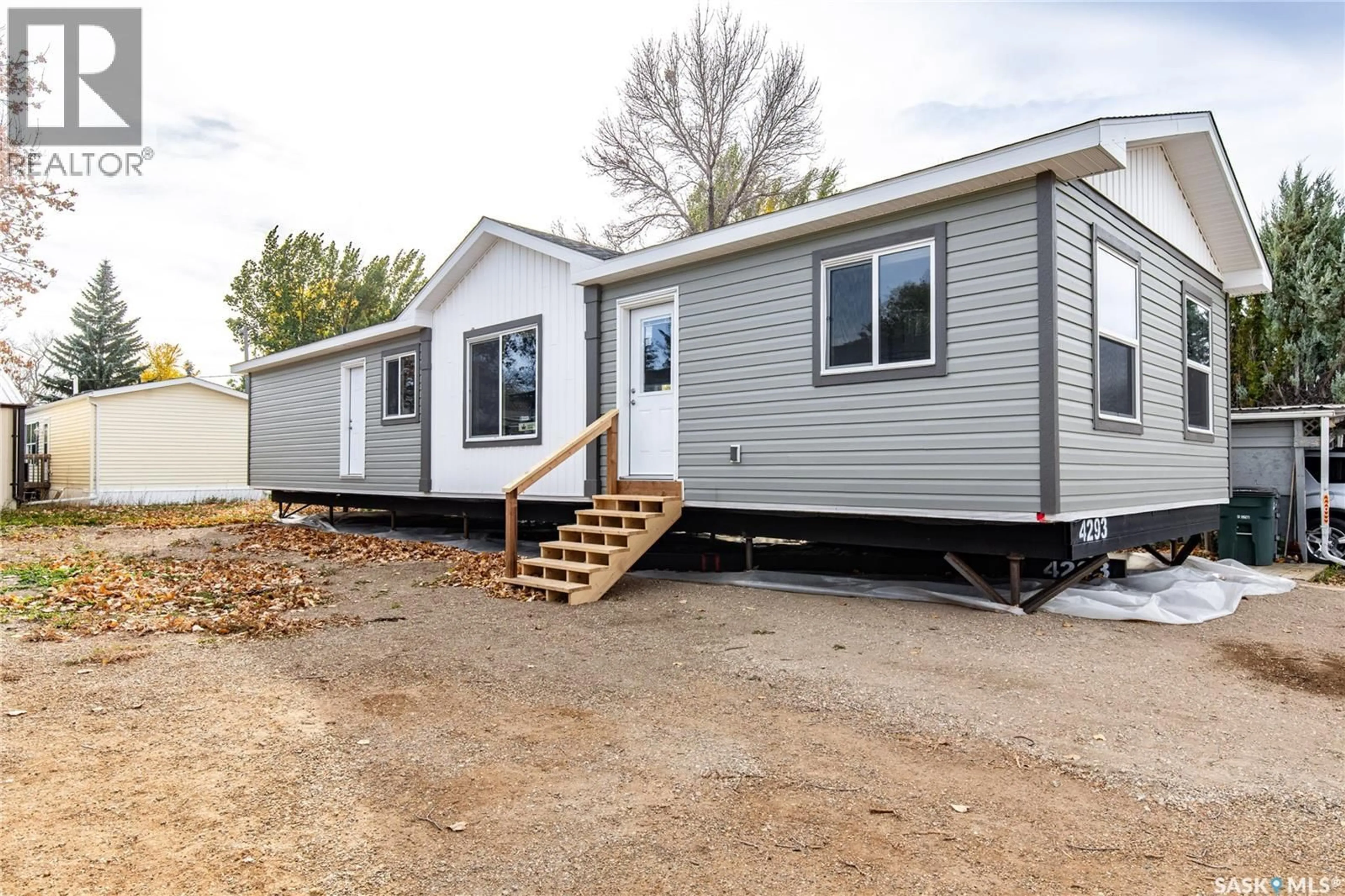 Home with vinyl exterior material, street for E18 - 1455 9TH AVENUE, Moose Jaw Saskatchewan S6J1C6