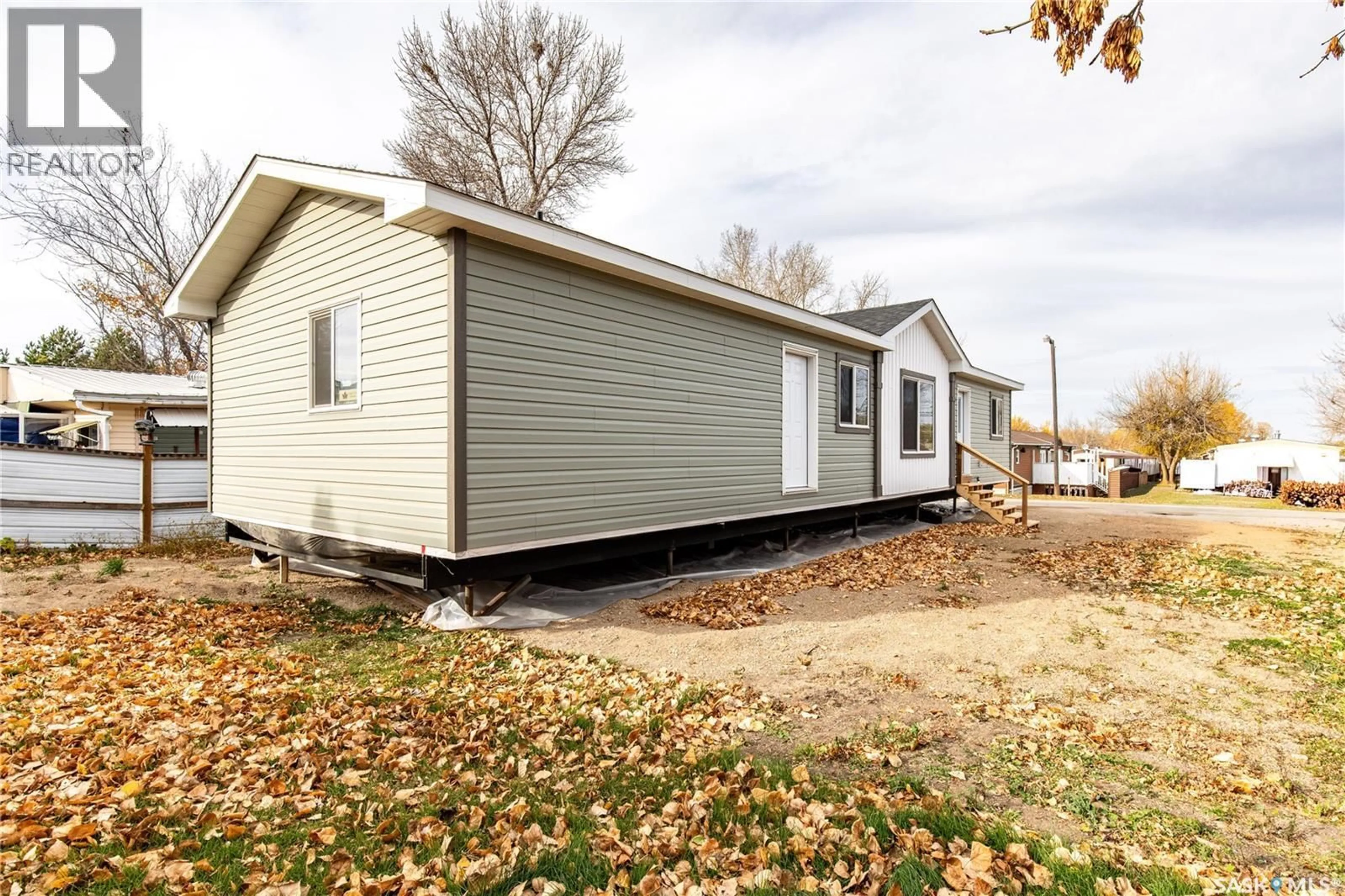 Home with vinyl exterior material, street for E18 - 1455 9TH AVENUE, Moose Jaw Saskatchewan S6J1C6