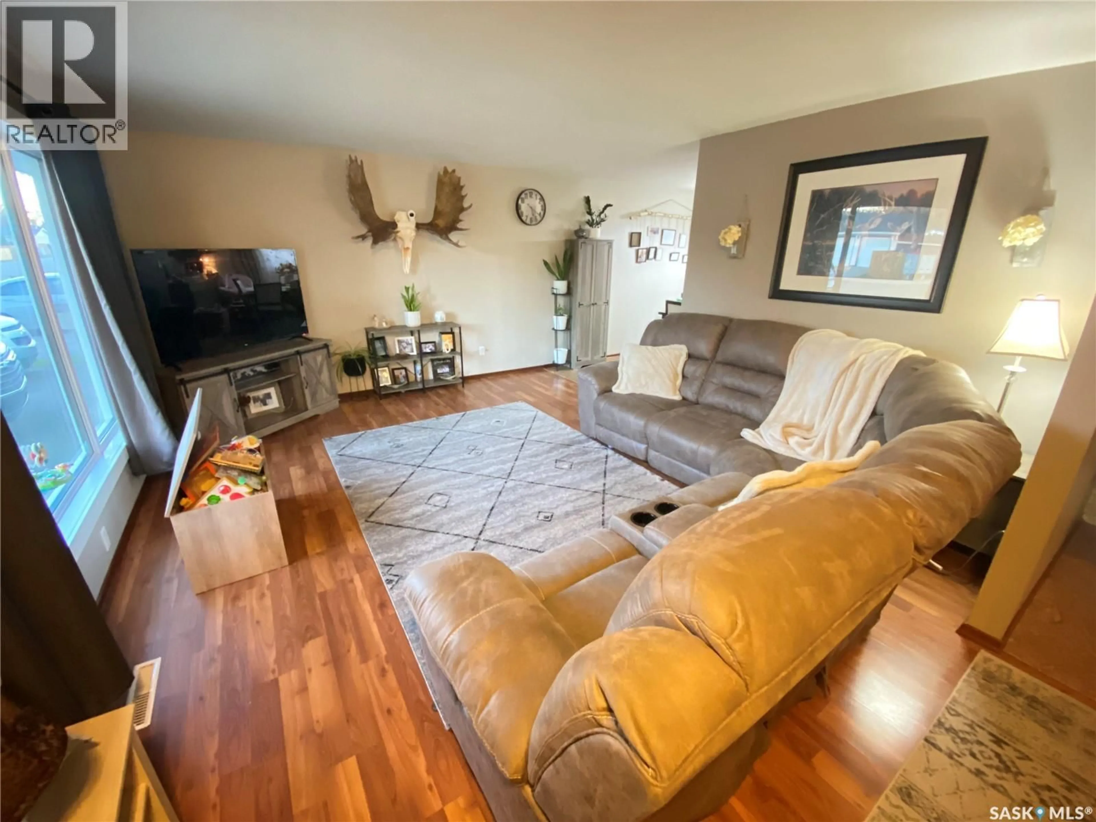 Living room with furniture, wood/laminate floor for 78 CLAREWOOD CRESCENT, Yorkton Saskatchewan S3N2V2