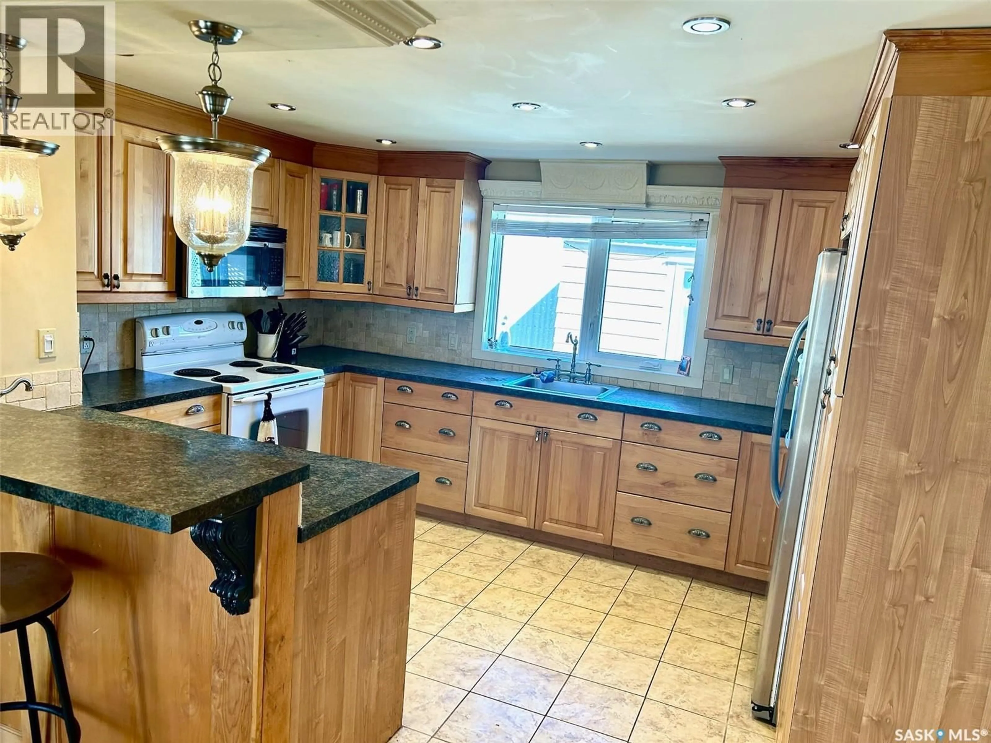 Open concept kitchen, ceramic/tile floor for SW - 23 106 1ST AVENUE, Weyburn Saskatchewan S4H2J1
