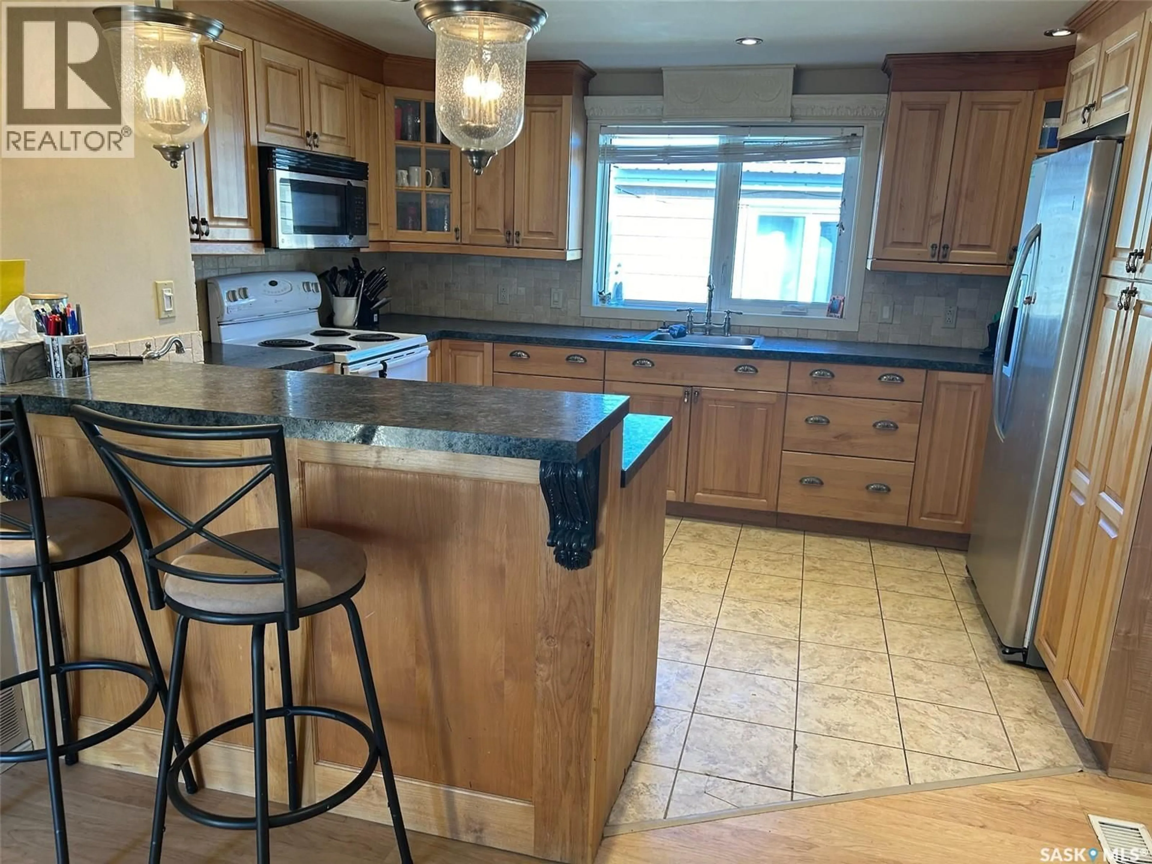 Open concept kitchen, ceramic/tile floor for SW - 23 106 1ST AVENUE, Weyburn Saskatchewan S4H2J1
