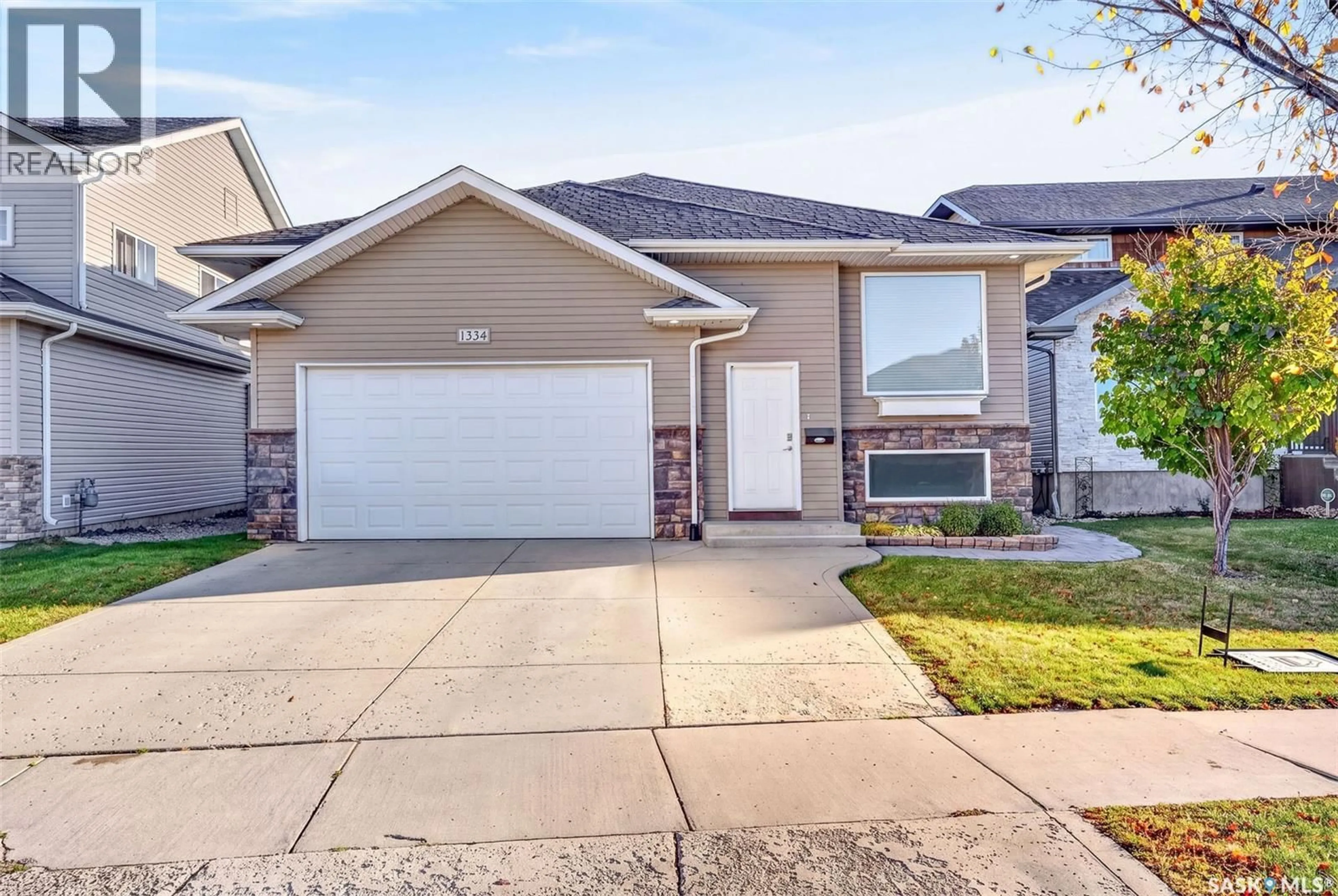 Home with vinyl exterior material, street for 1334 STENSRUD ROAD, Saskatoon Saskatchewan S7W0B9