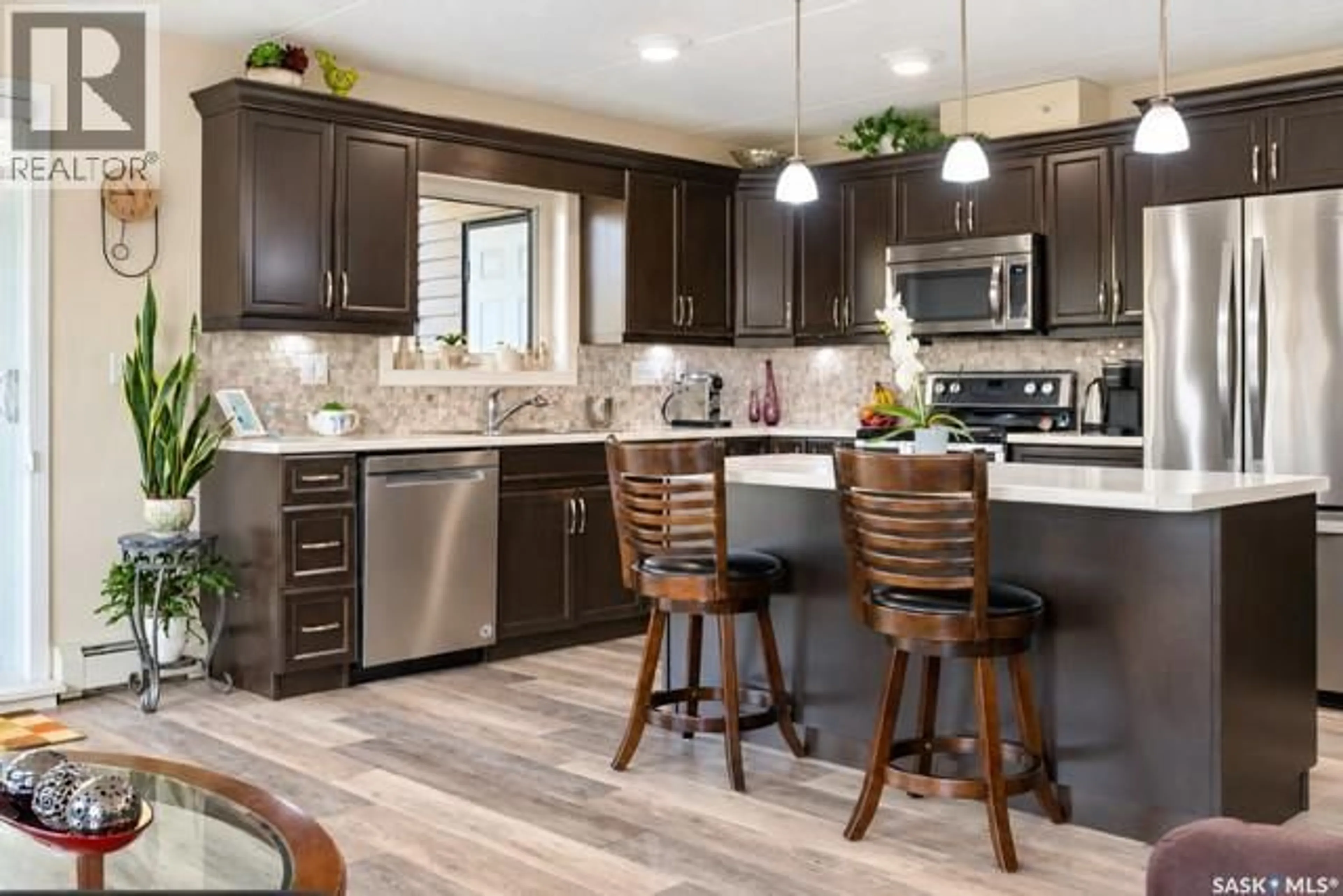 Open concept kitchen, wood/laminate floor for 307 1213 9TH STREET, Humboldt Saskatchewan S0K2A0