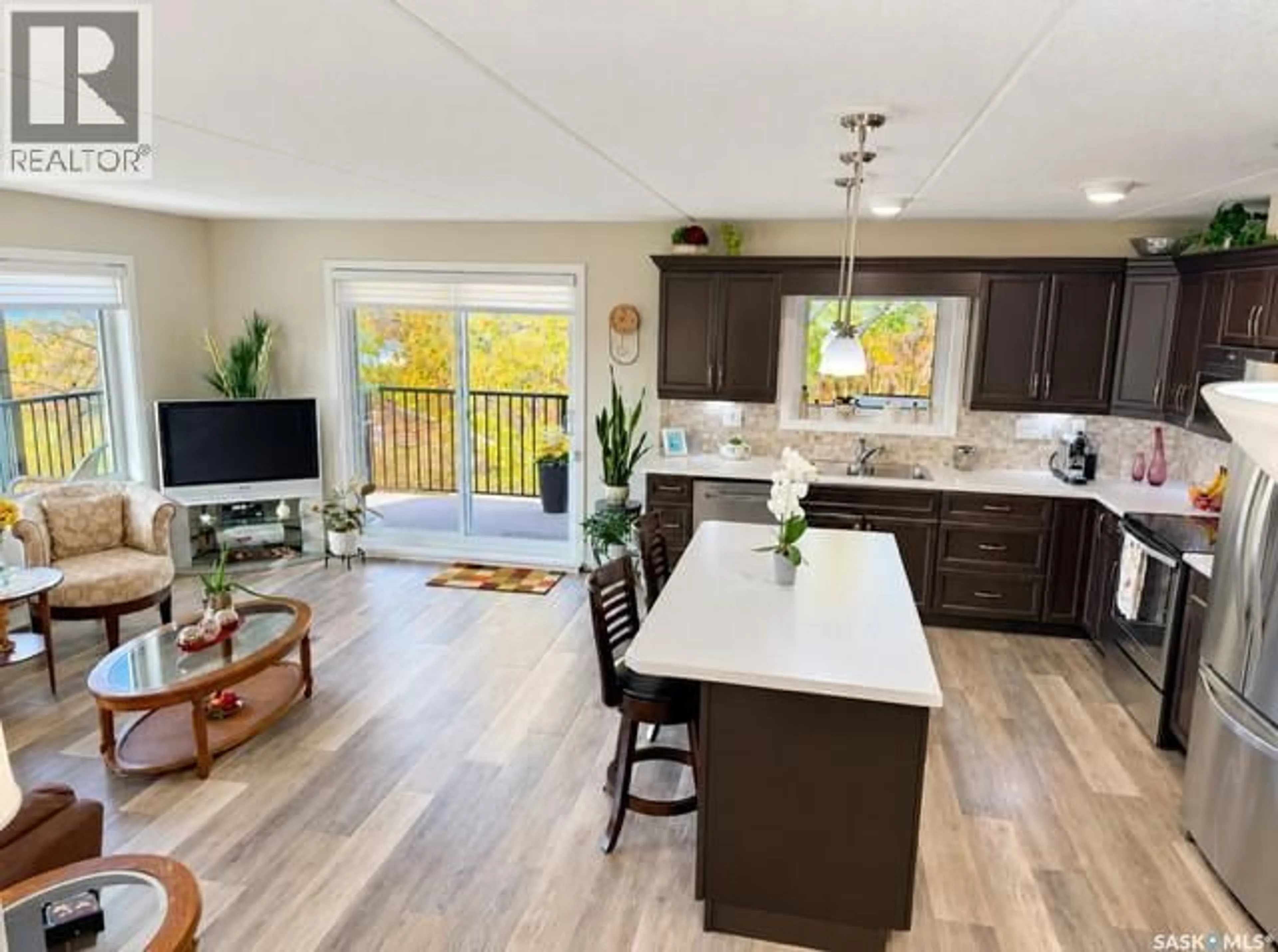 Open concept kitchen, wood/laminate floor for 307 1213 9TH STREET, Humboldt Saskatchewan S0K2A0