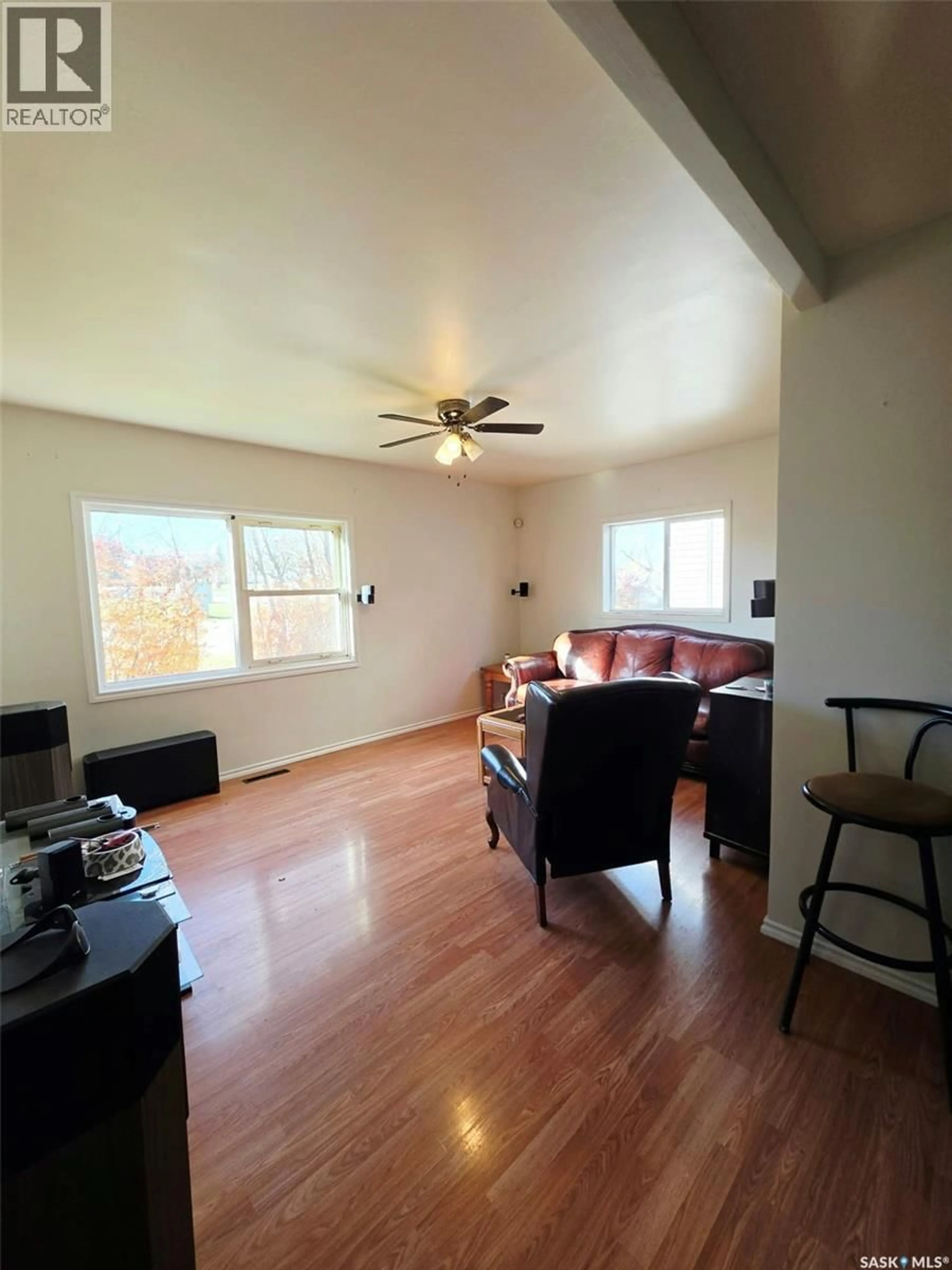 Living room with furniture, wood/laminate floor for 233 ANCONA STREET, Esterhazy Saskatchewan S0A0X0