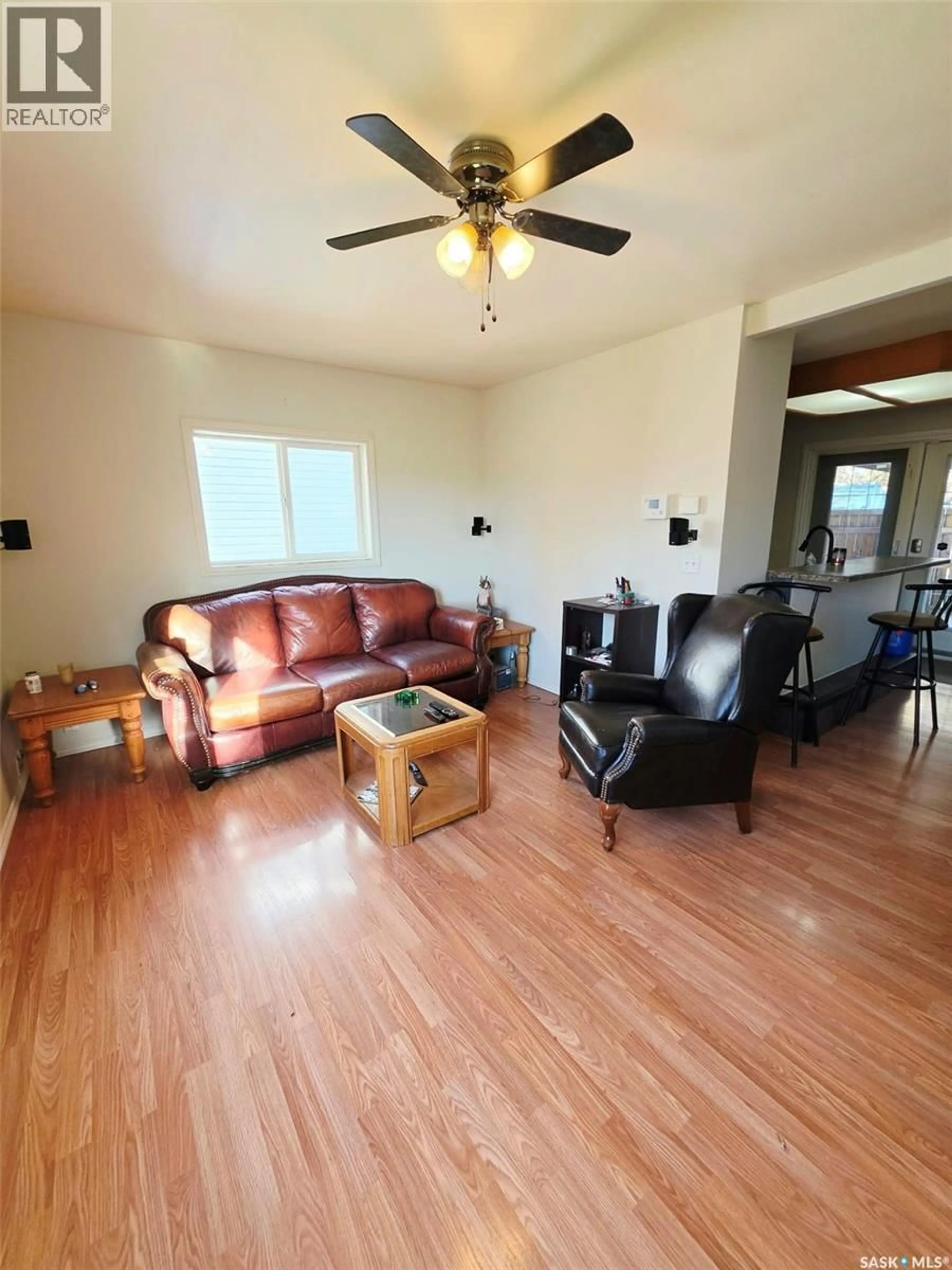 Living room with furniture, wood/laminate floor for 233 ANCONA STREET, Esterhazy Saskatchewan S0A0X0