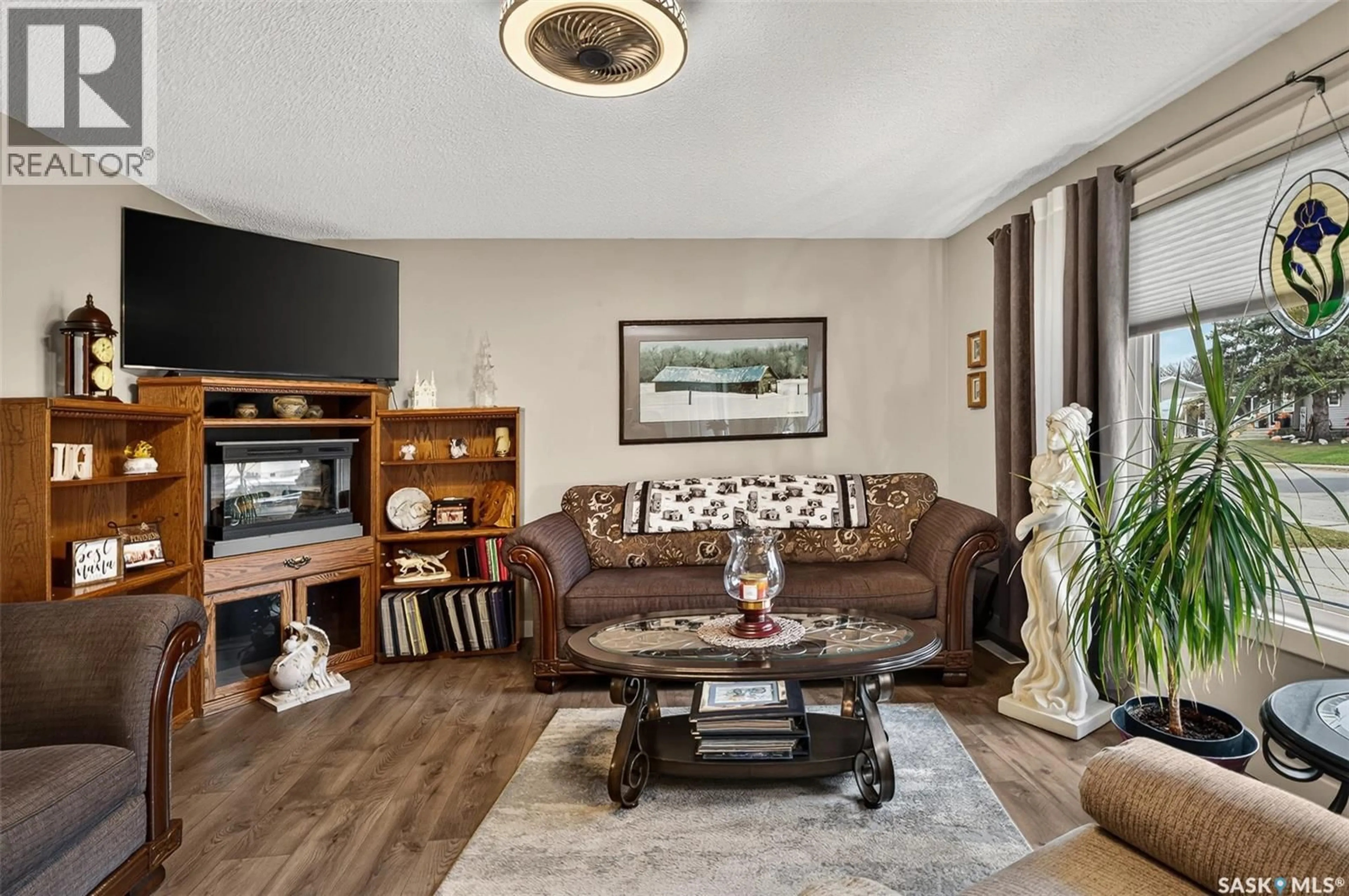 Living room with furniture, wood/laminate floor for 1056 SIMCOE STREET, Moose Jaw Saskatchewan S6H3J2