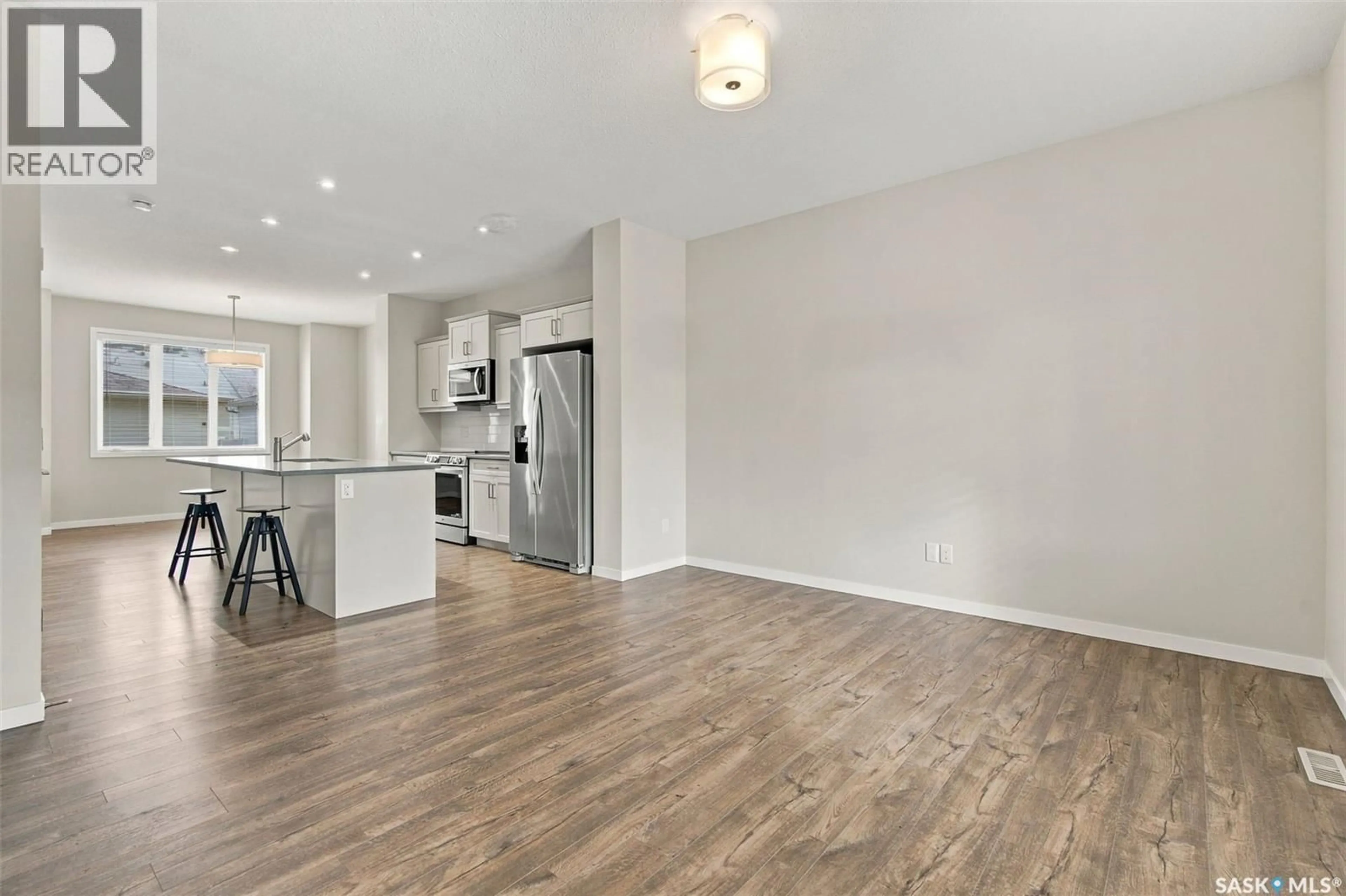 Open concept kitchen, wood/laminate floor for 5644 VEDETTE ROAD, Regina Saskatchewan S4W0P8