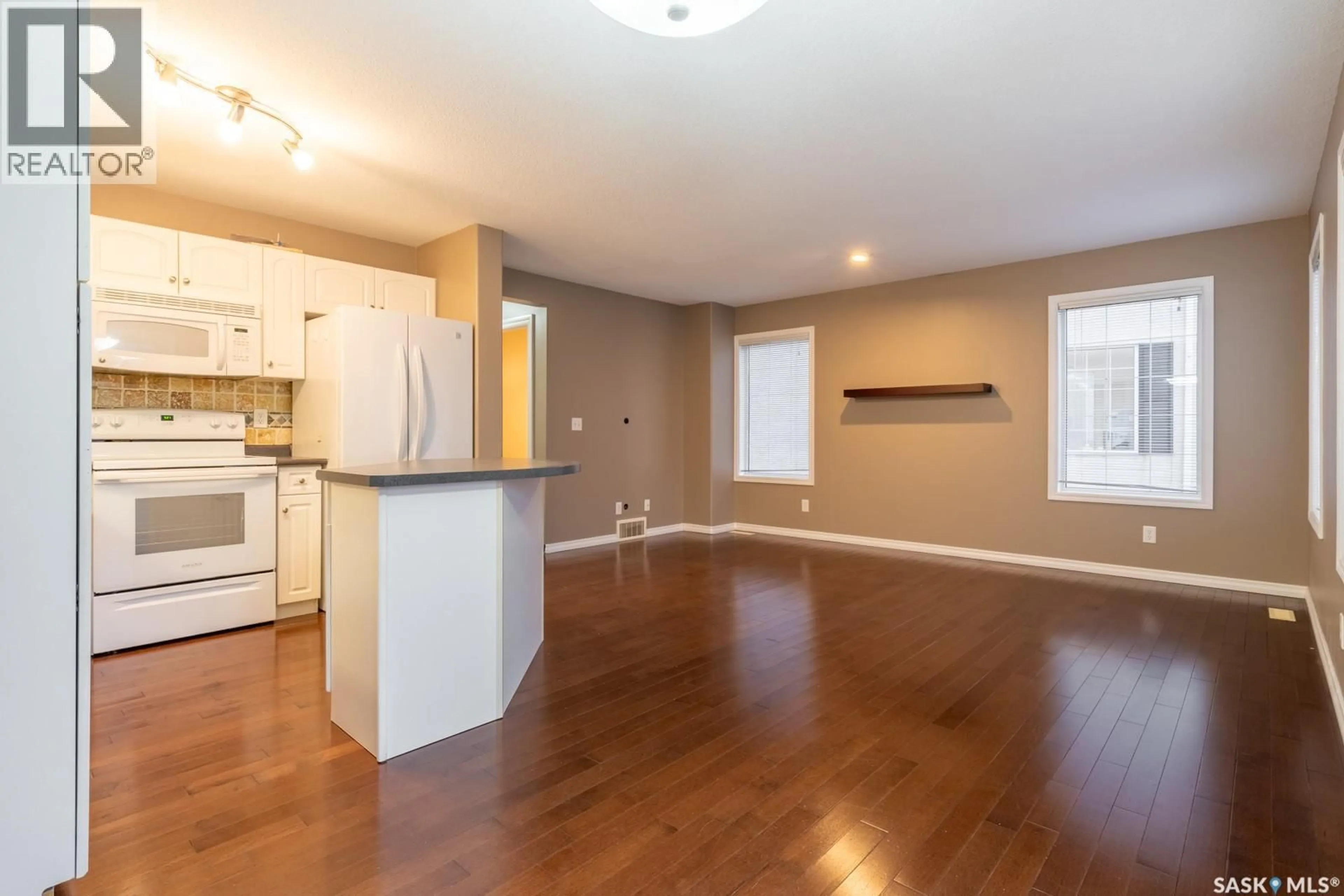 Open concept kitchen, wood/laminate floor for 39 2400 TELL PLACE, Regina Saskatchewan S4V3E3