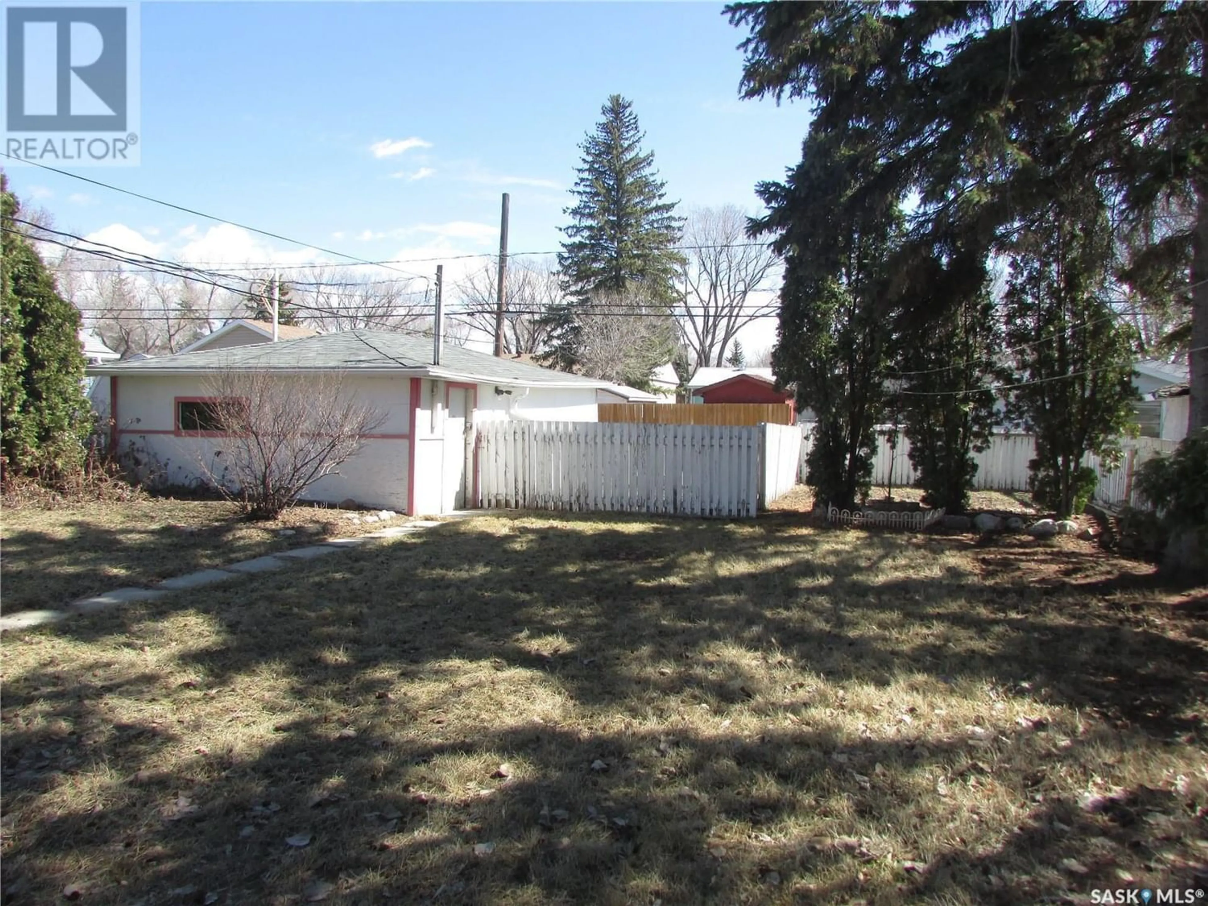 Frontside or backside of a home, the fenced backyard for 1736 St John STREET, Regina Saskatchewan S4P1R7