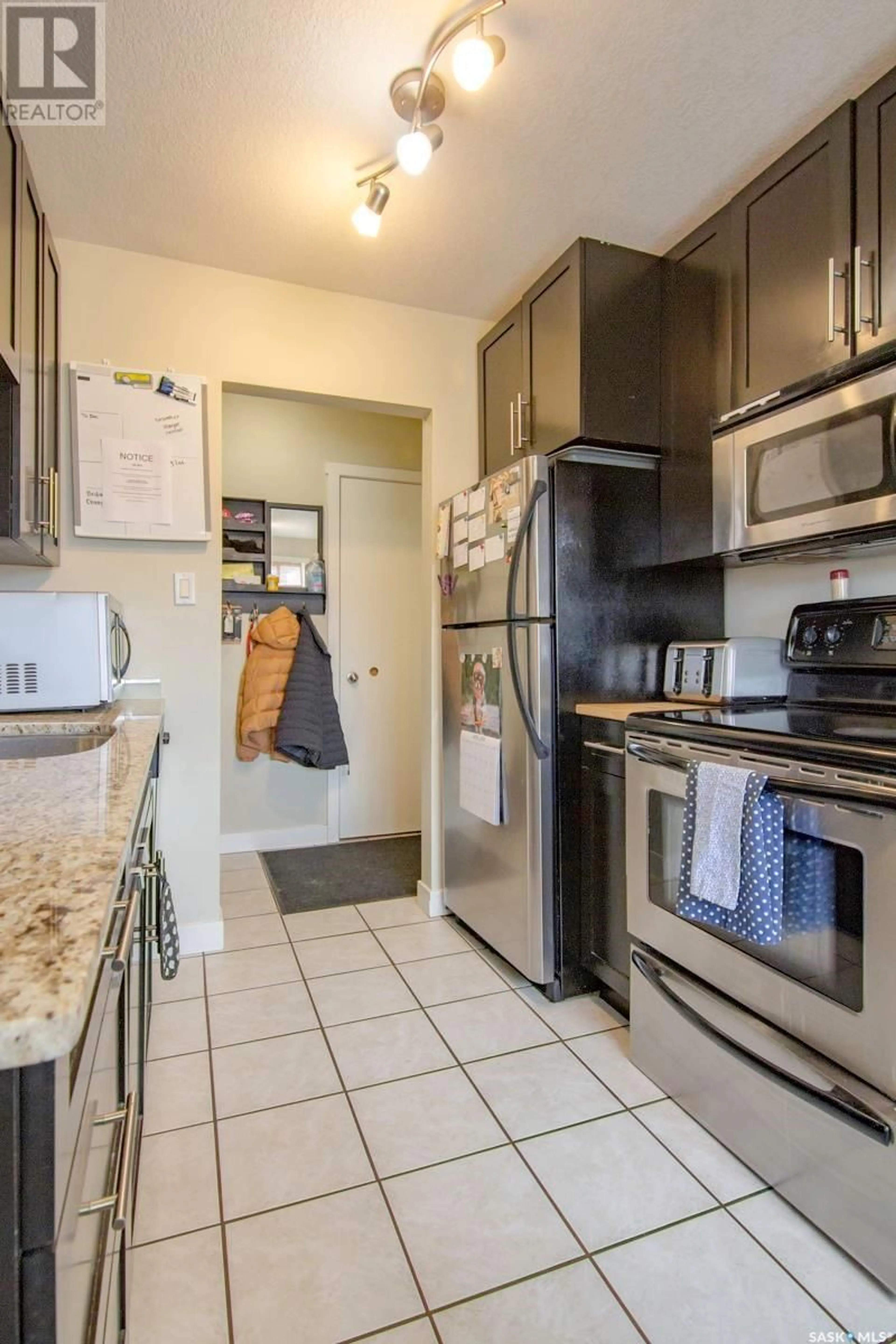 Kitchen with laundary machines for 11 1604 MAIN STREET, Saskatoon Saskatchewan S7H0L3