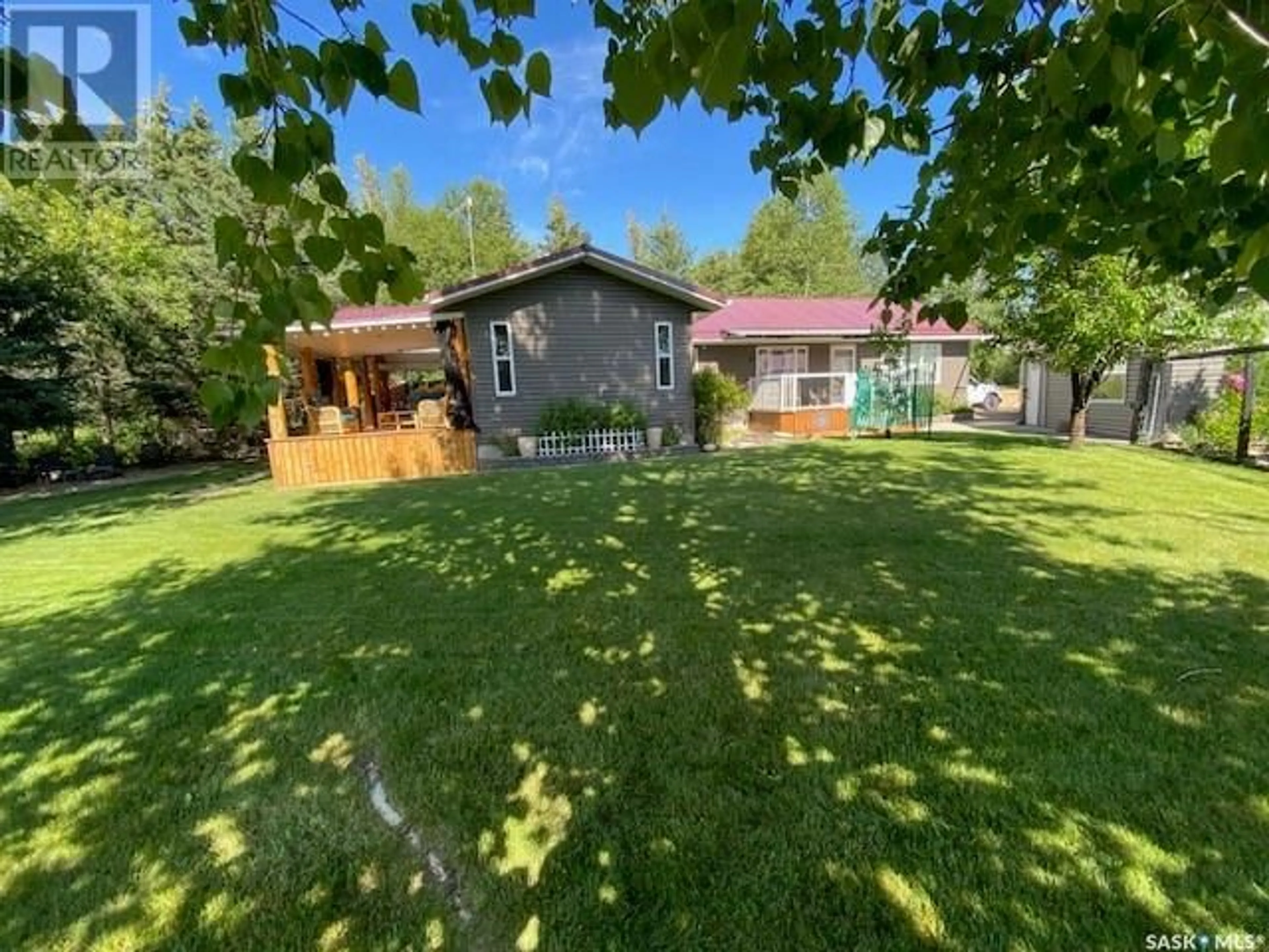 Frontside or backside of a home, the fenced backyard for 412 Mary Anne PLACE, Emma Lake Saskatchewan S0J0N0