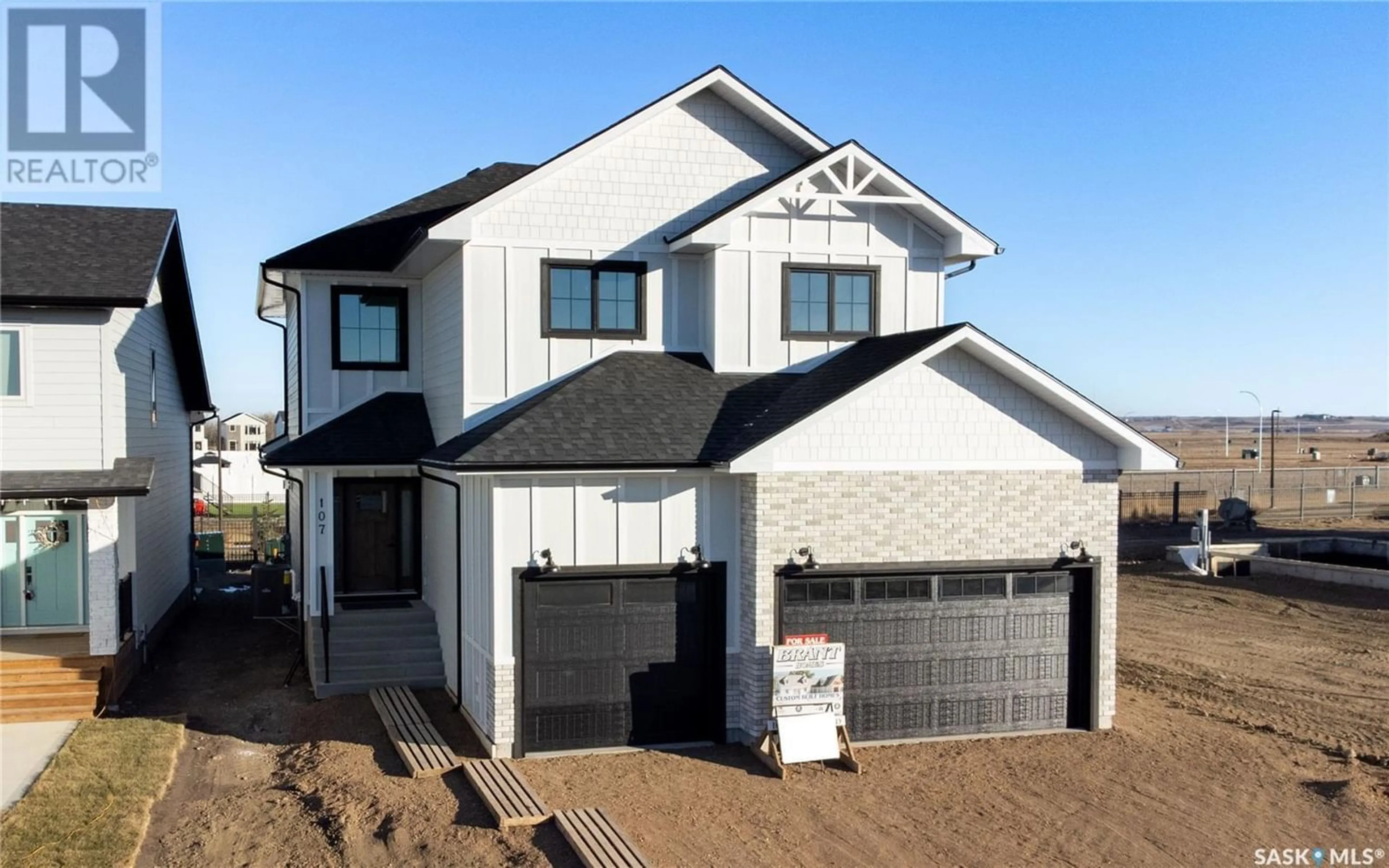 Frontside or backside of a home for 107 Woolf BEND, Saskatoon Saskatchewan S7W0Z6