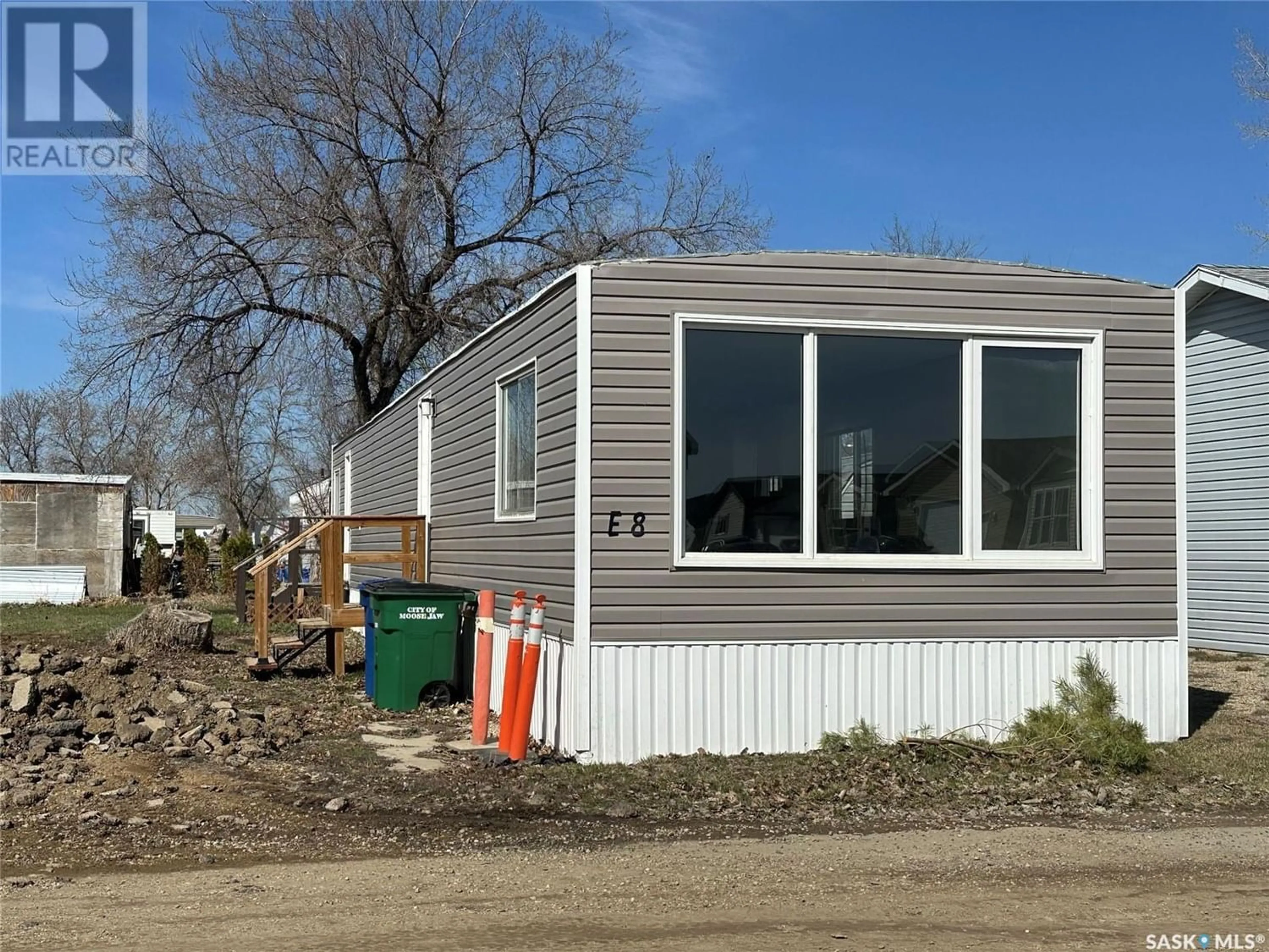Home with vinyl exterior material for E8 - 1455 9th AVENUE NE, Moose Jaw Saskatchewan S6J1C6