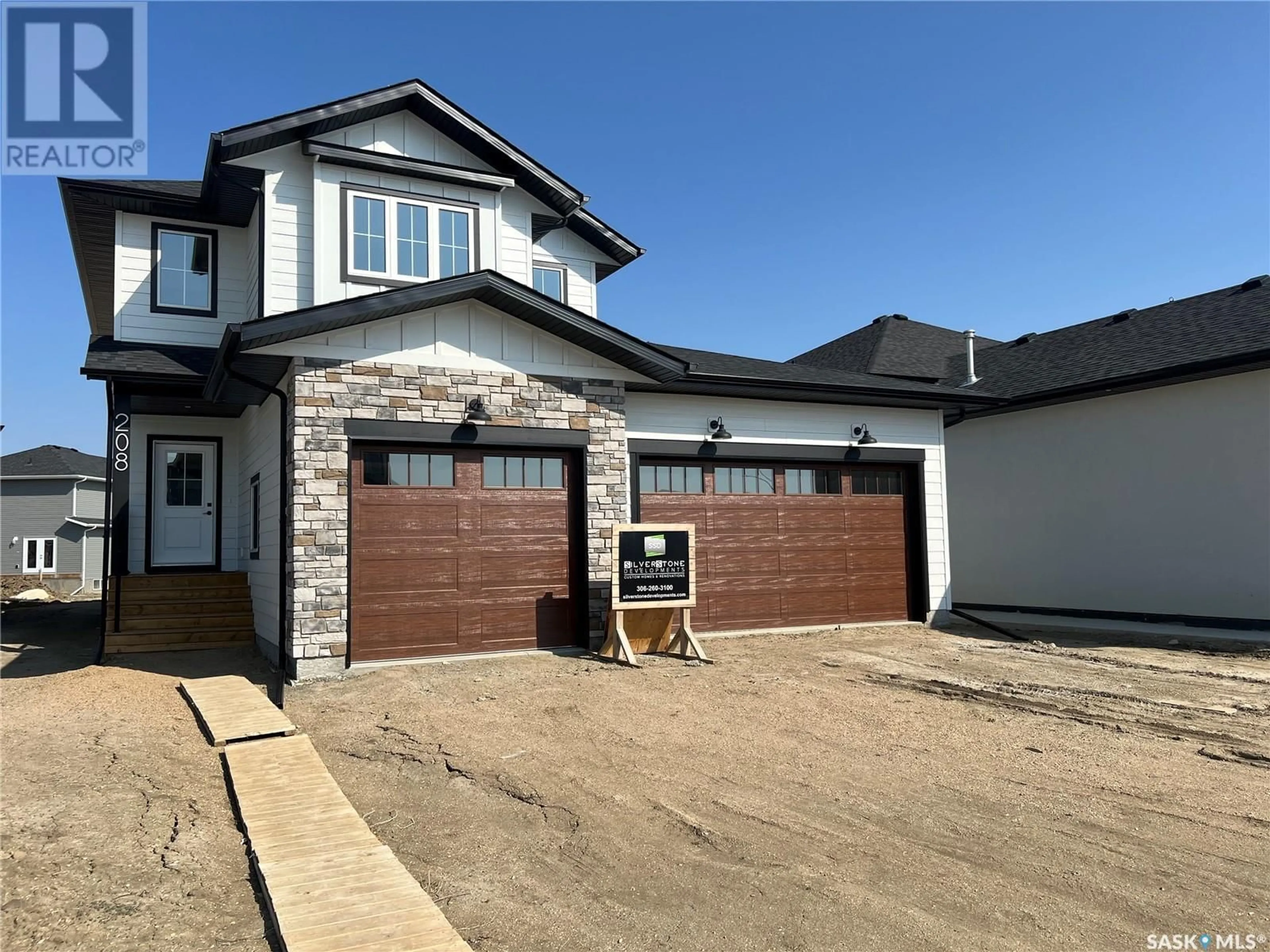 Frontside or backside of a home for 208 Woolf PLACE, Saskatoon Saskatchewan S7W0Z6