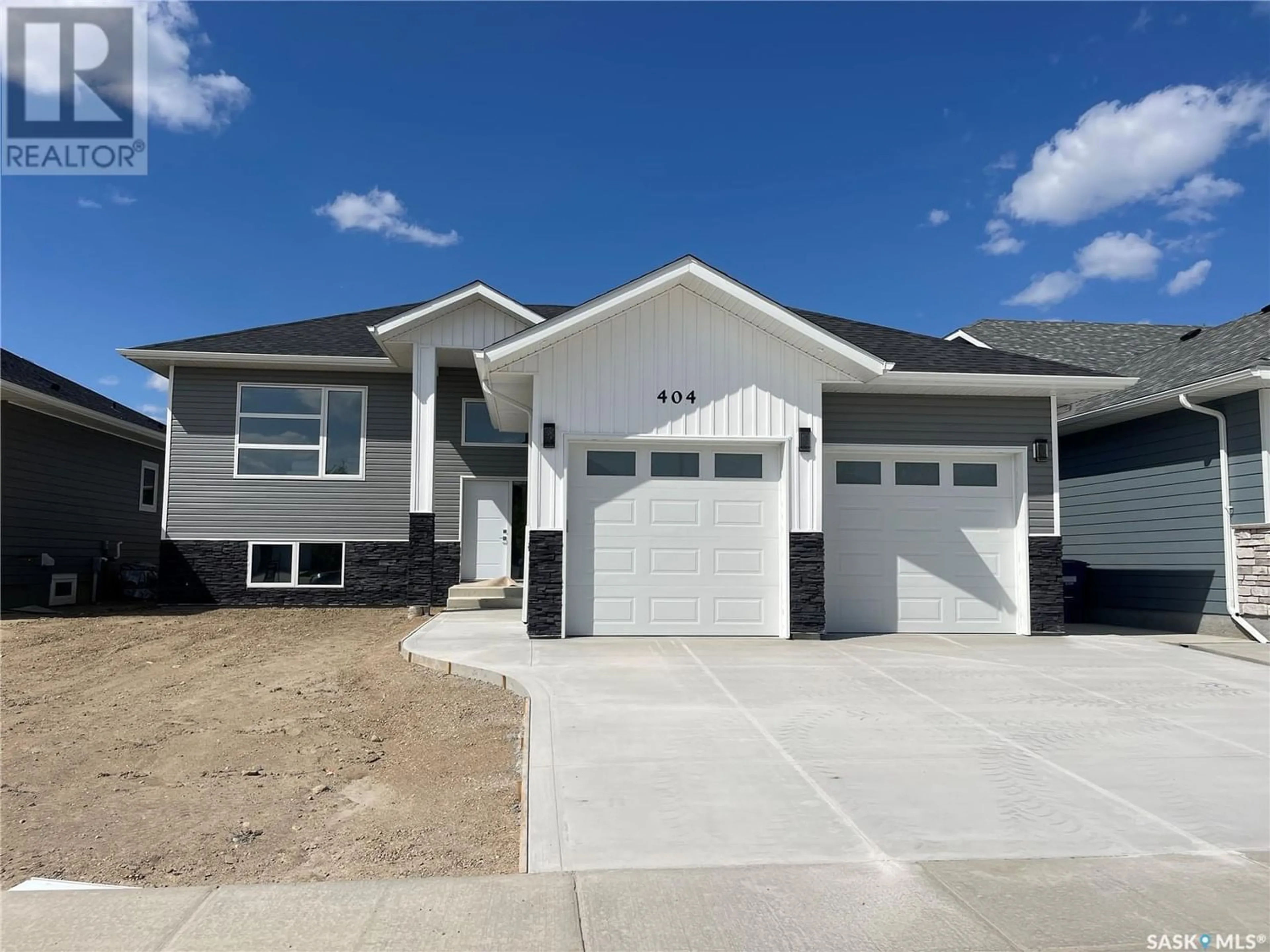 Frontside or backside of a home for 404 Clubhouse BOULEVARD W, Warman Saskatchewan S0K0A1