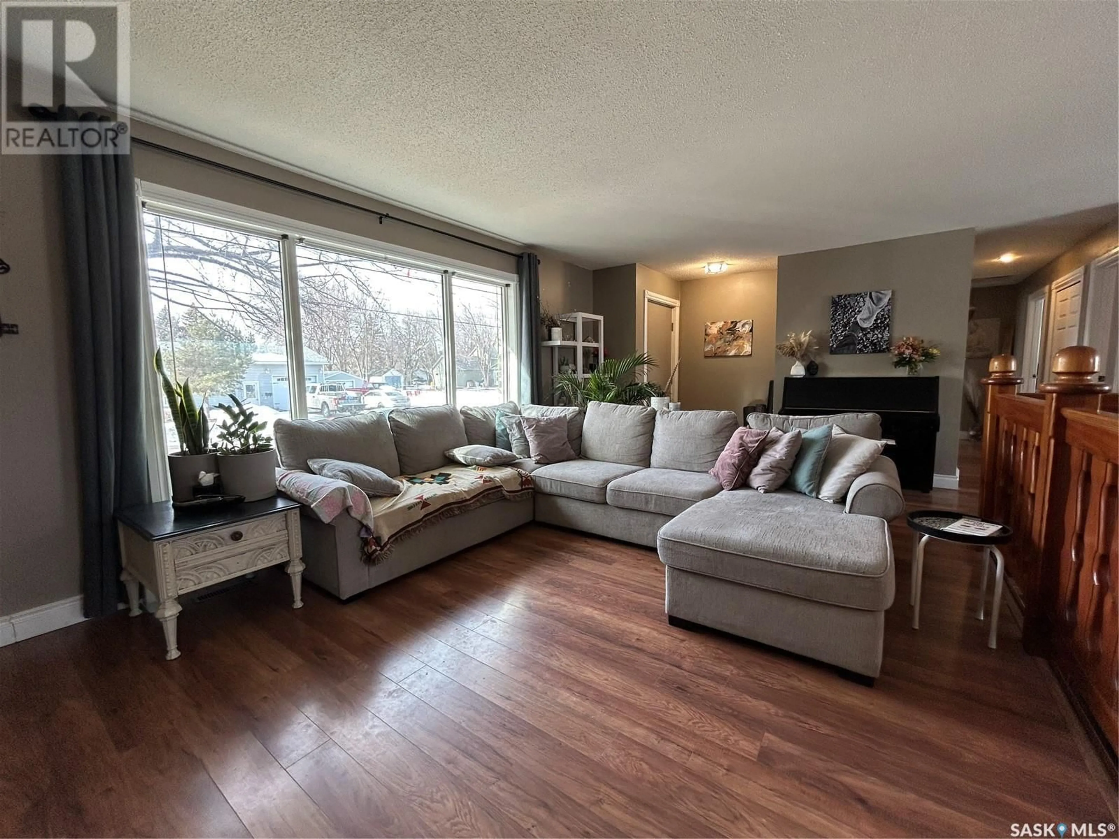 Living room with furniture, wood/laminate floor for 848 BERYL AVENUE, Oxbow Saskatchewan S0C2B0