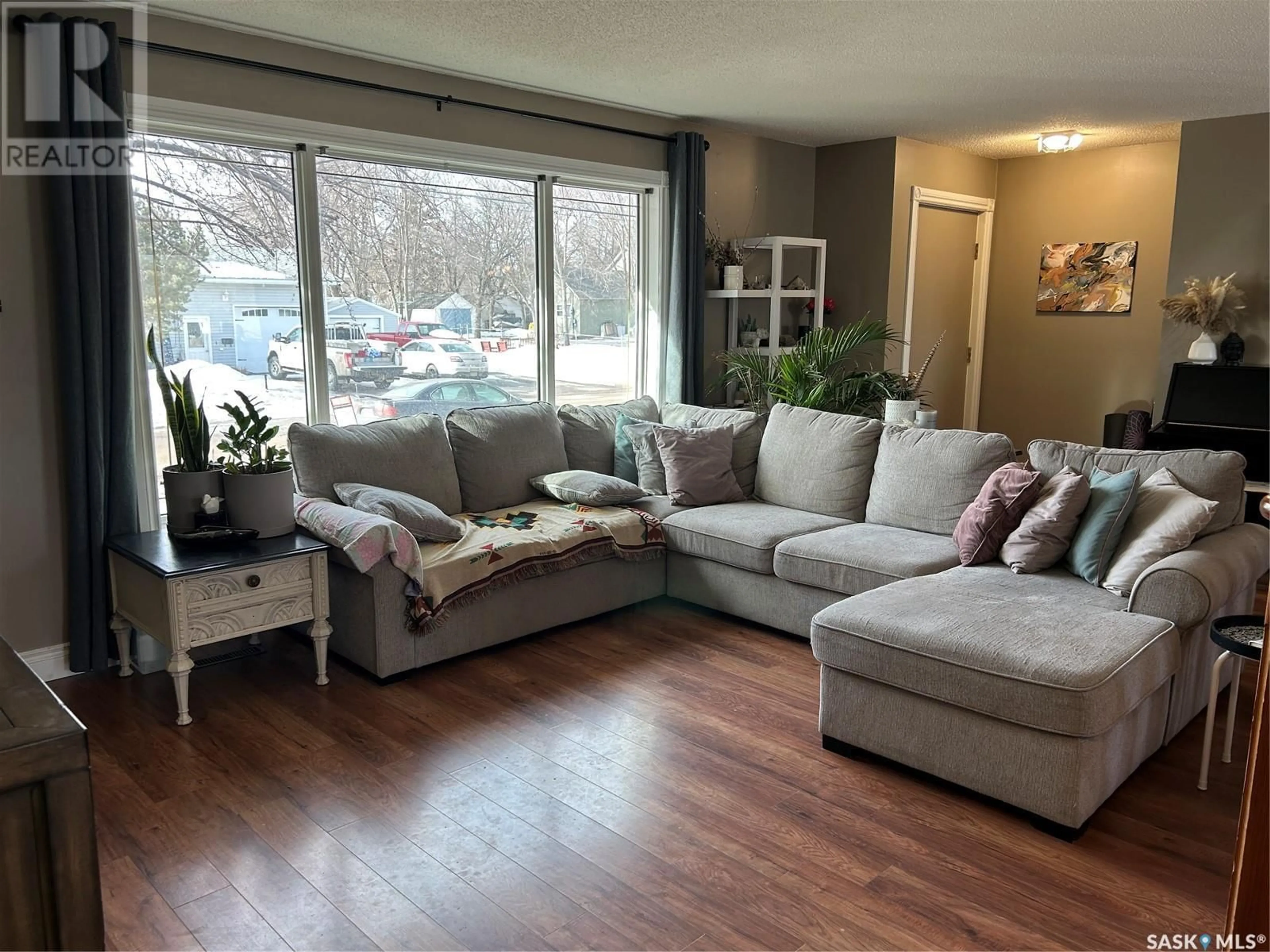 Living room with furniture, wood/laminate floor for 848 BERYL AVENUE, Oxbow Saskatchewan S0C2B0