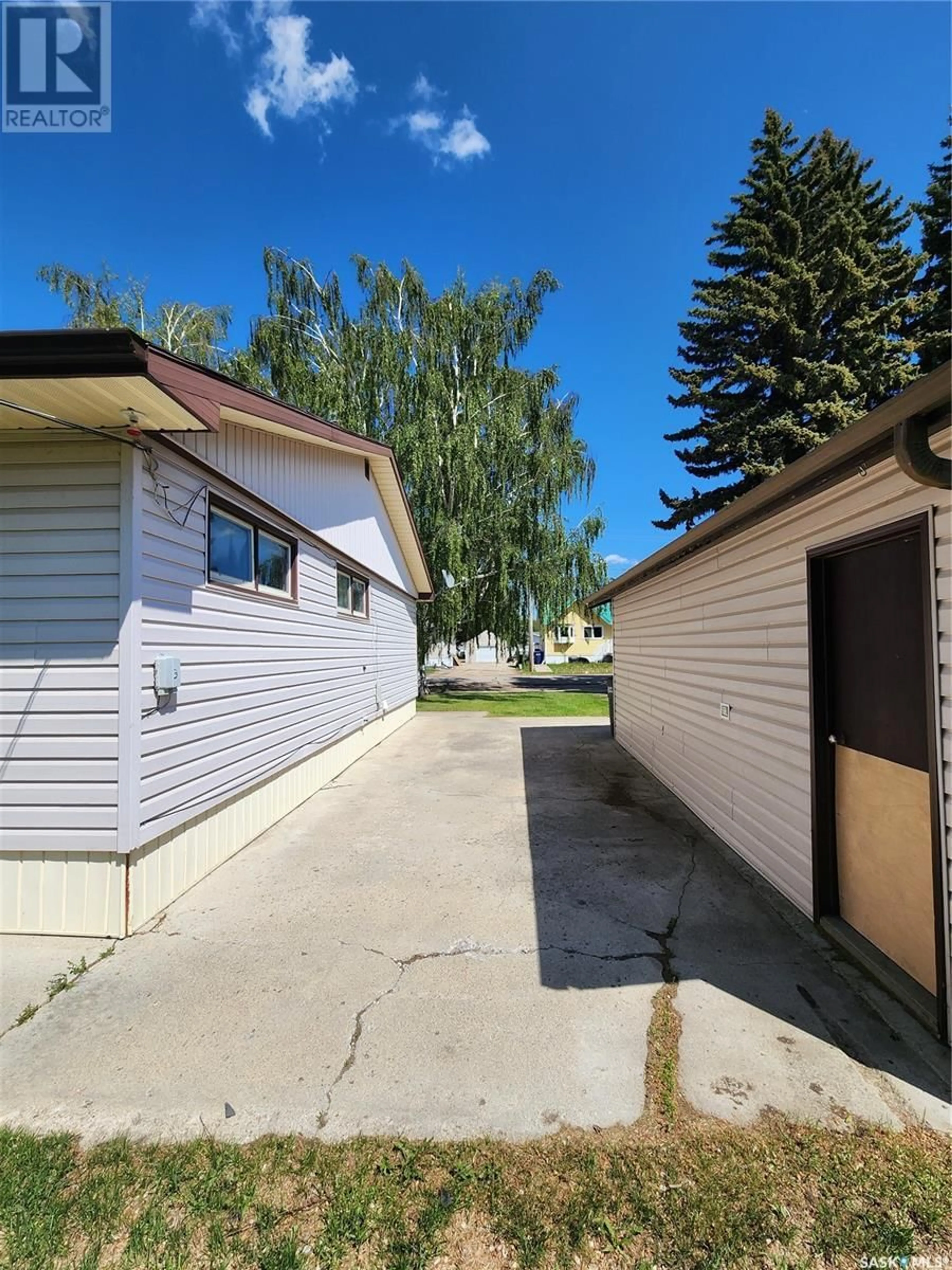 A pic from exterior of the house or condo, the fenced backyard for 910 Qu'Appelle STREET, Grenfell Saskatchewan S0G2B0