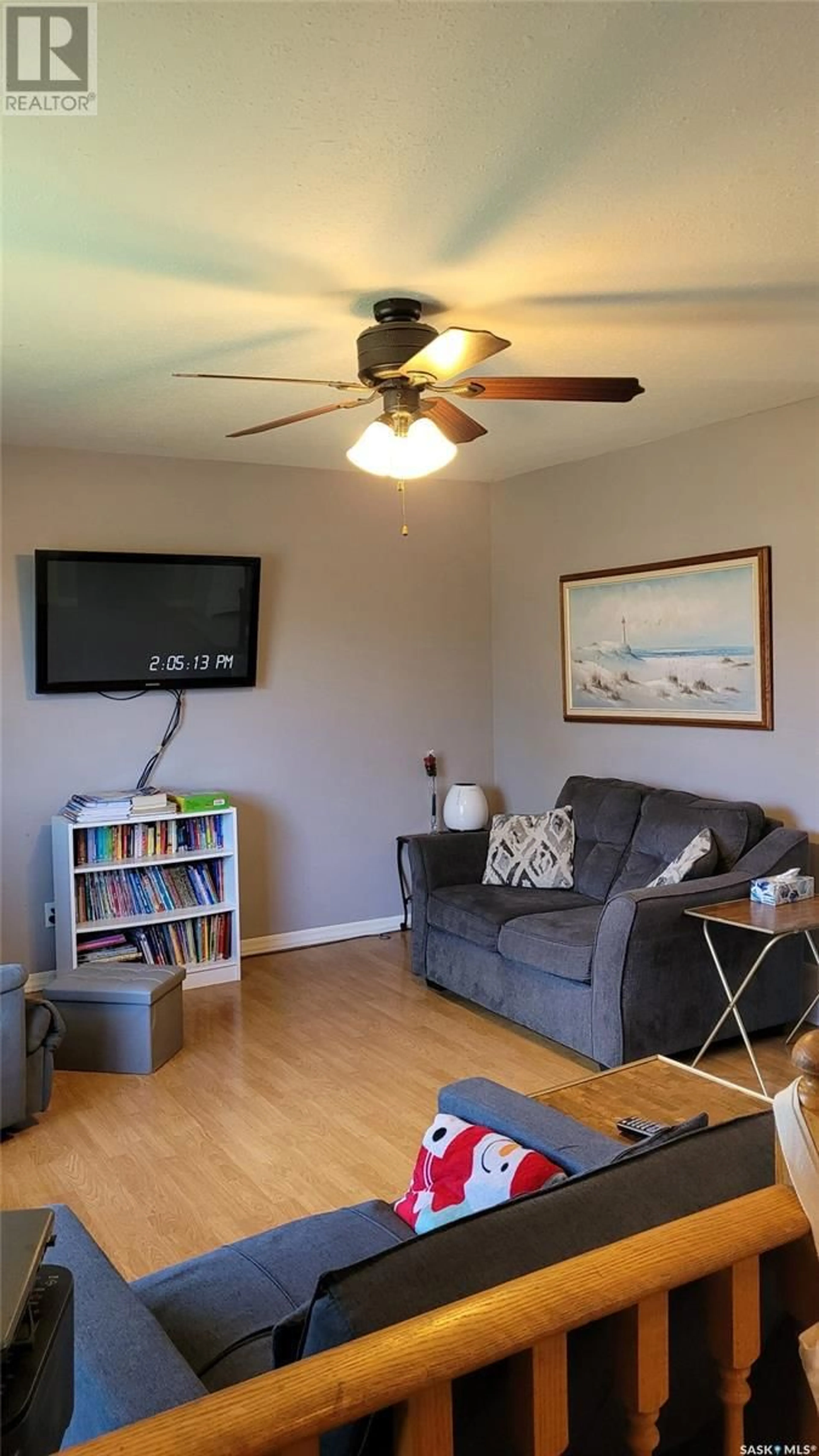 Living room with furniture, wood/laminate floor for 702 6TH STREET, Meadow Lake Saskatchewan S9X1J3