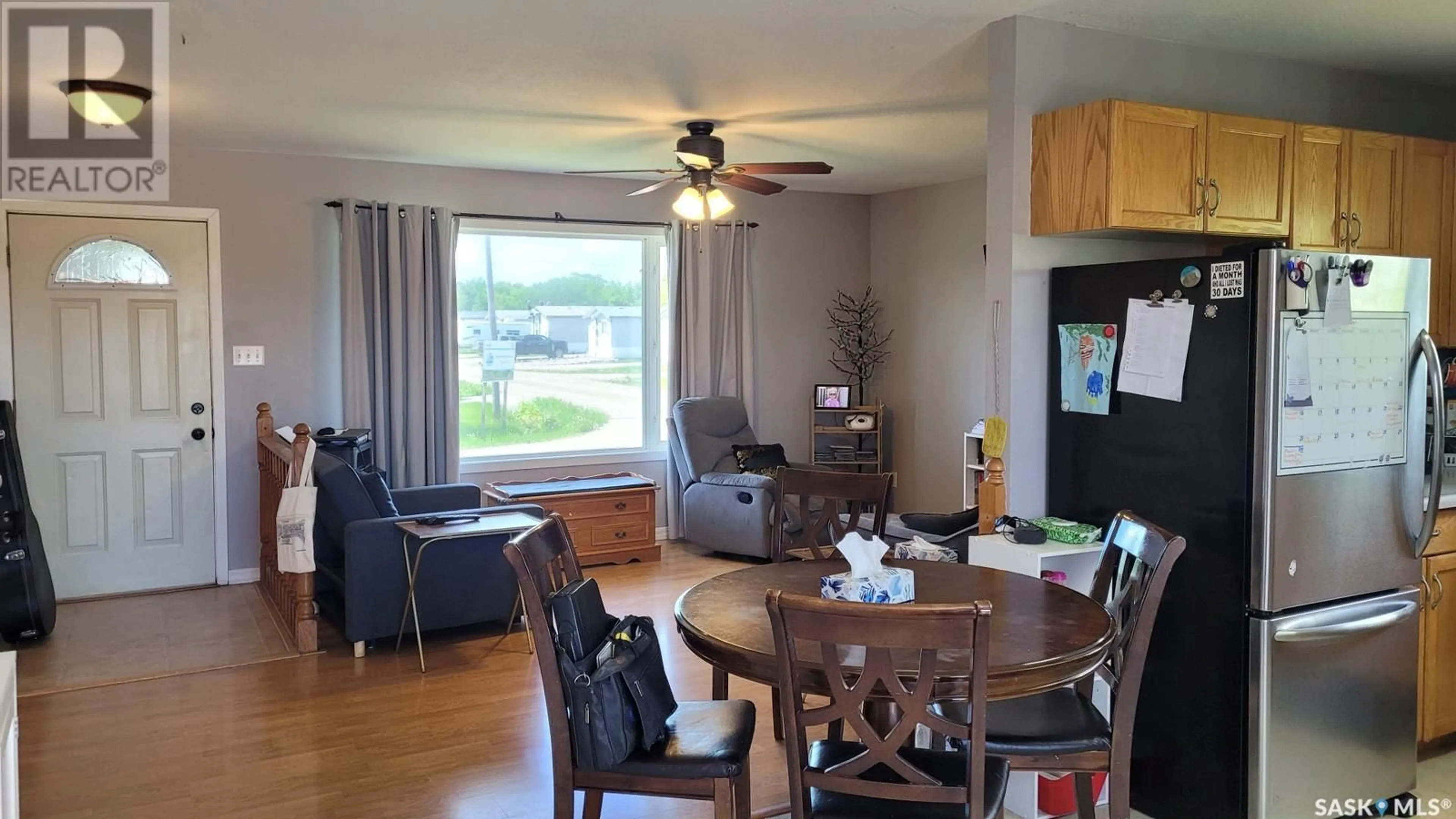 Living room with furniture, wood/laminate floor for 702 6TH STREET, Meadow Lake Saskatchewan S9X1J3