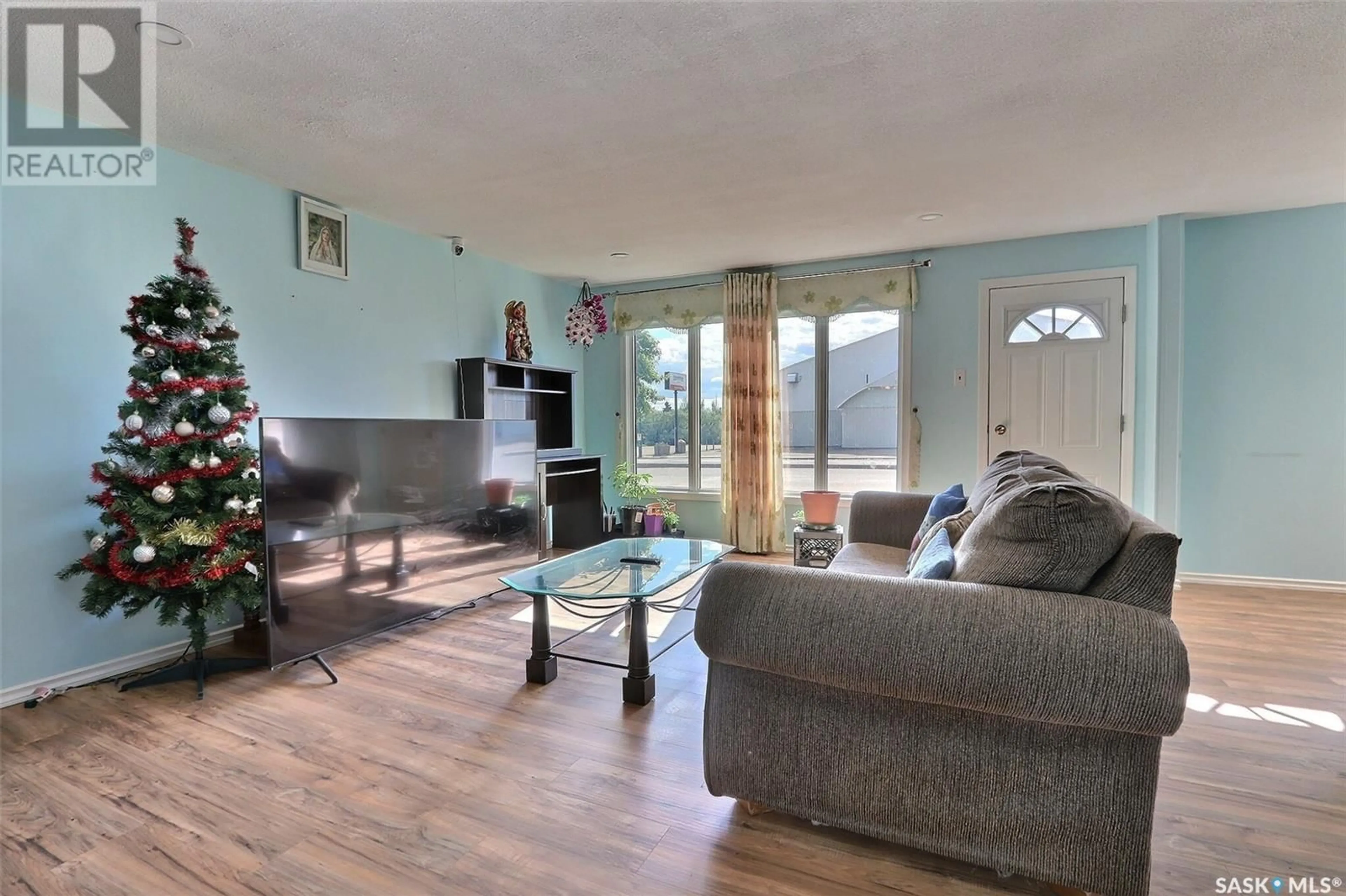 Living room with furniture, wood/laminate floor for 108 MAIN STREET, Shellbrook Saskatchewan S0J2E0