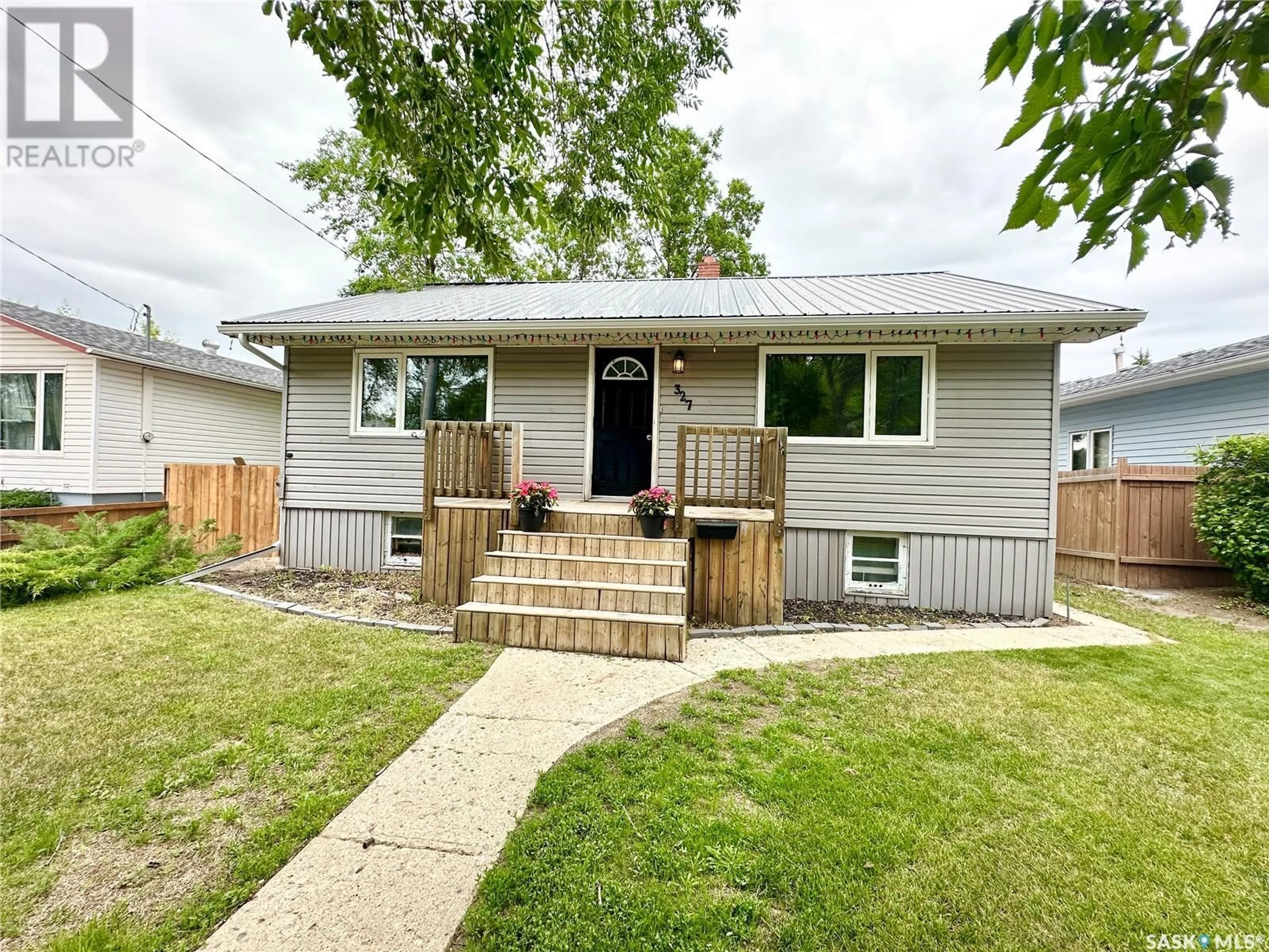 Frontside or backside of a home for 327 4th AVENUE S, Weyburn Saskatchewan S4H1X9