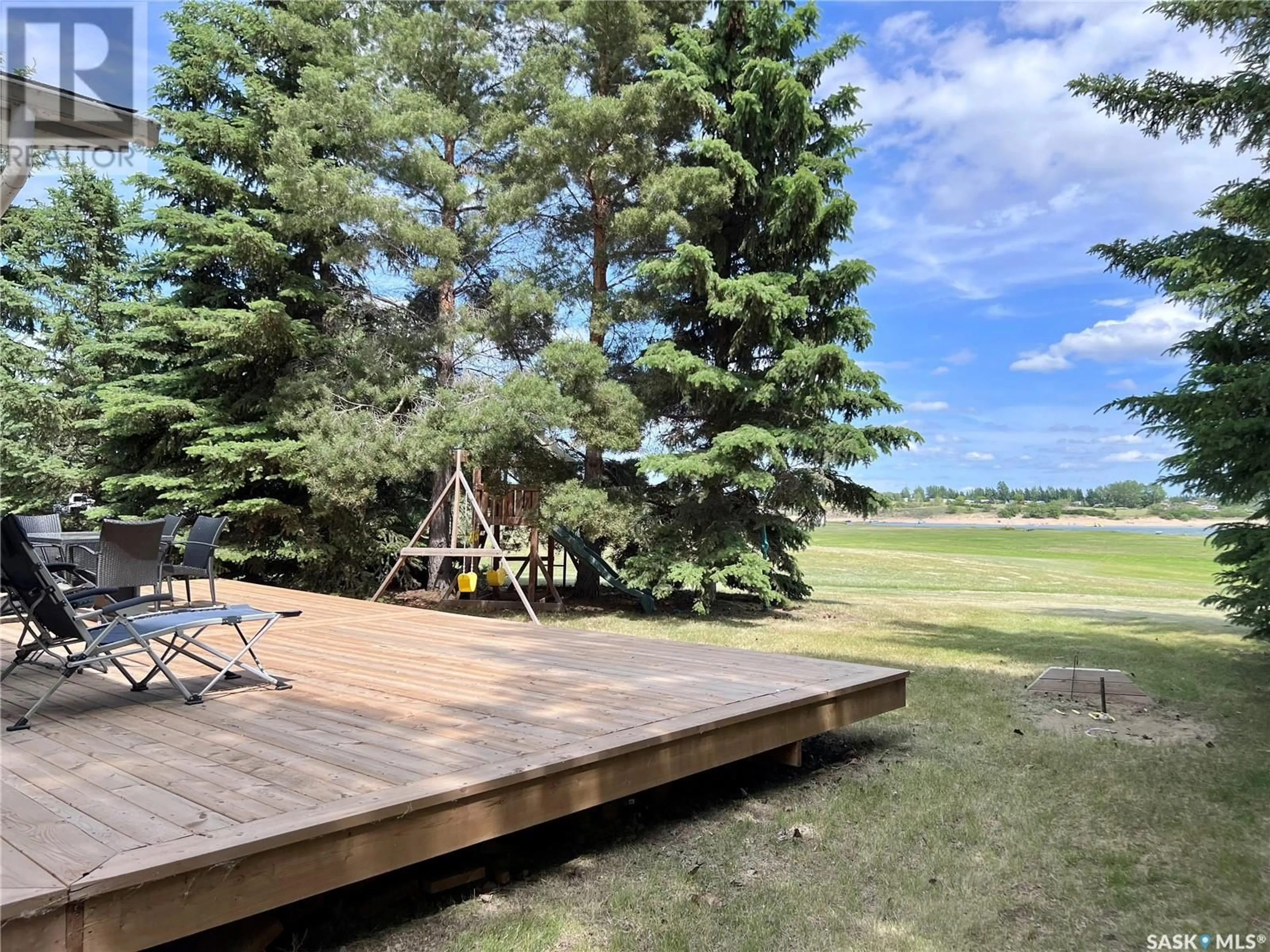 Patio, the fenced backyard for 210 Ruby DRIVE, Hitchcock Bay Saskatchewan S0L0G0