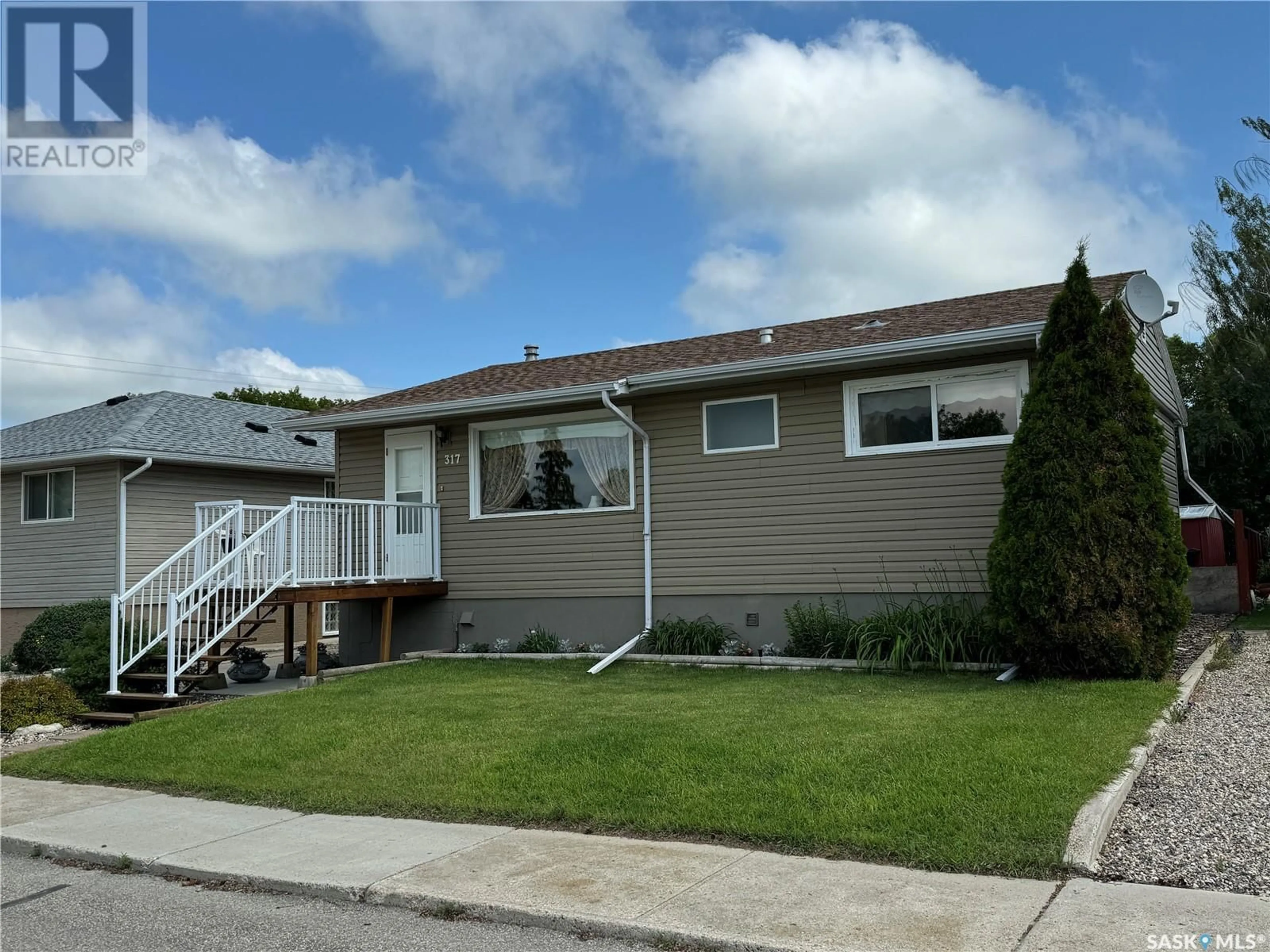 Frontside or backside of a home for 317 7th AVENUE W, Biggar Saskatchewan S0K0M0